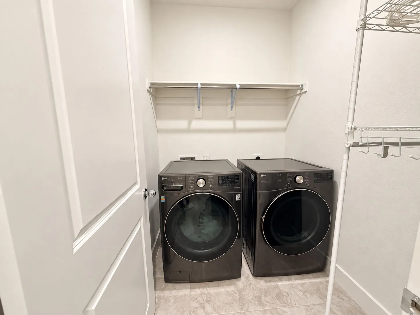 Laundry area with a permanent shelf and front-loading appliances