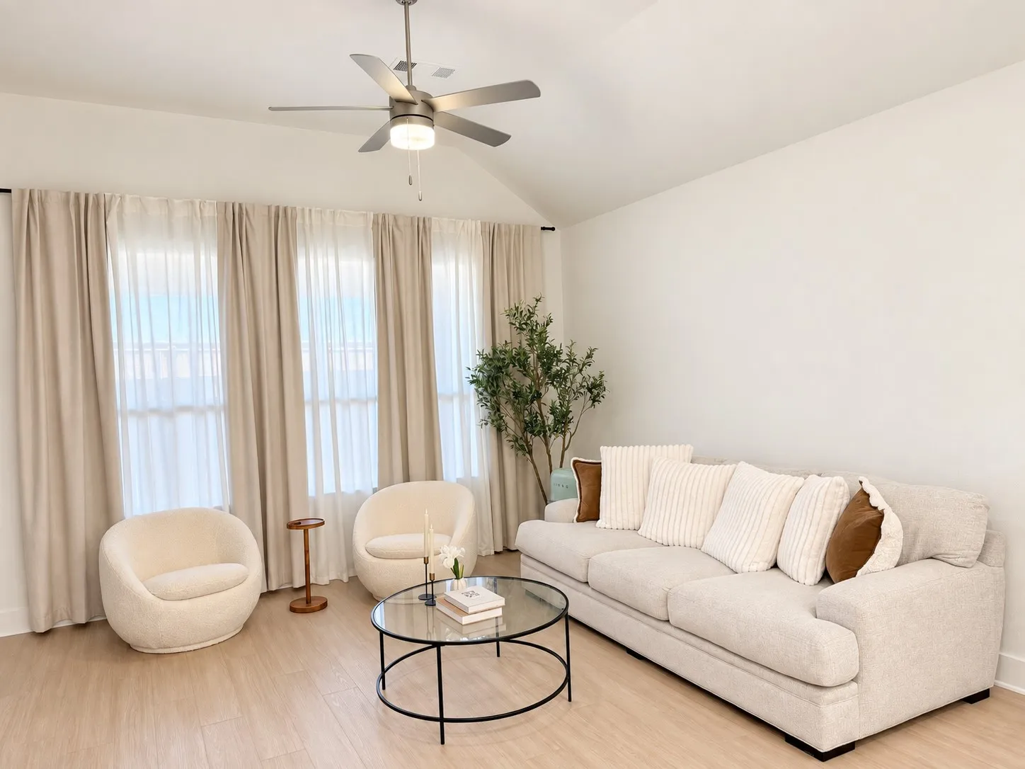 Vaulted ceiling with a brushed nickel ceiling fan