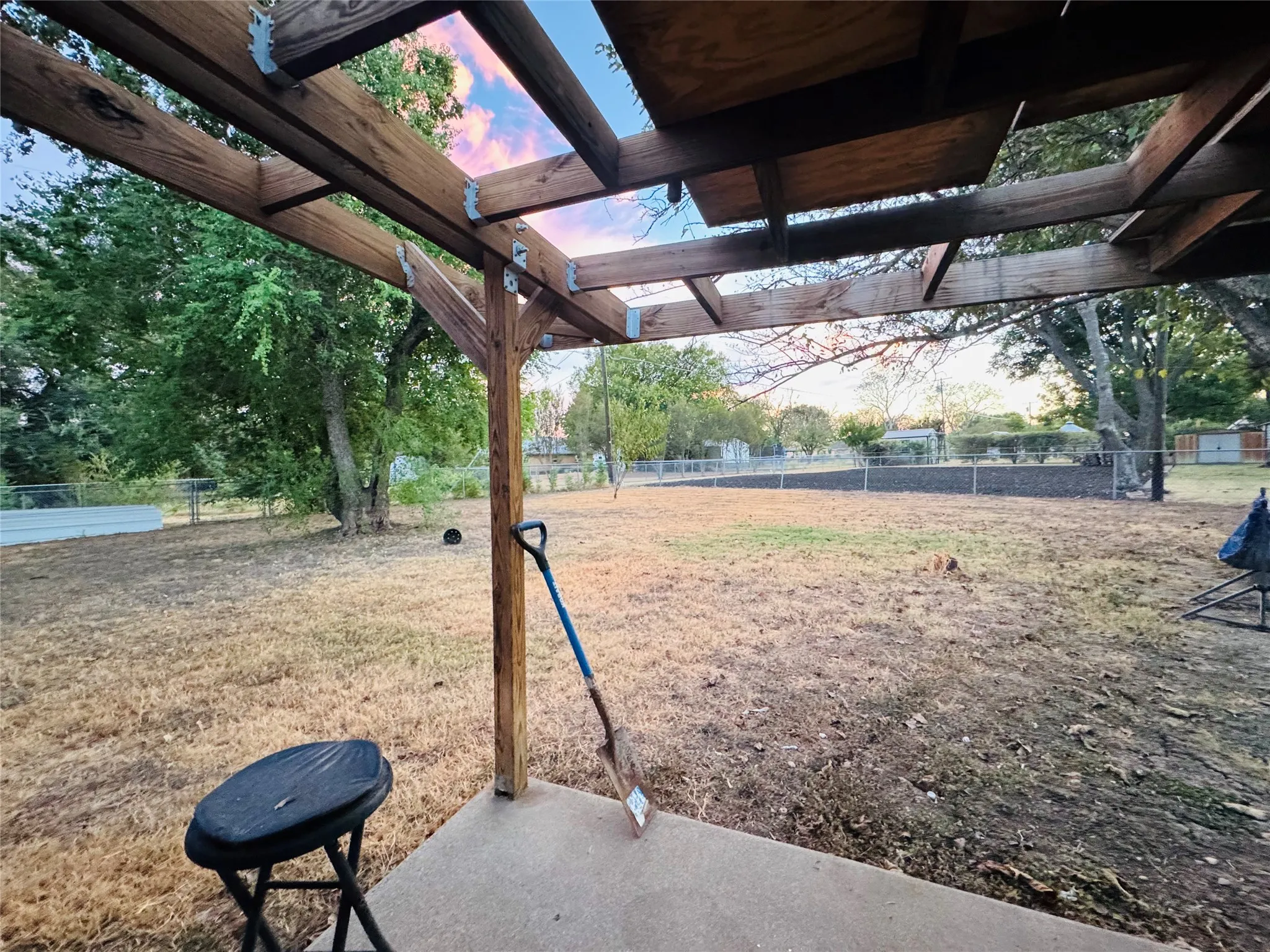 Concrete patio with a wood pergola