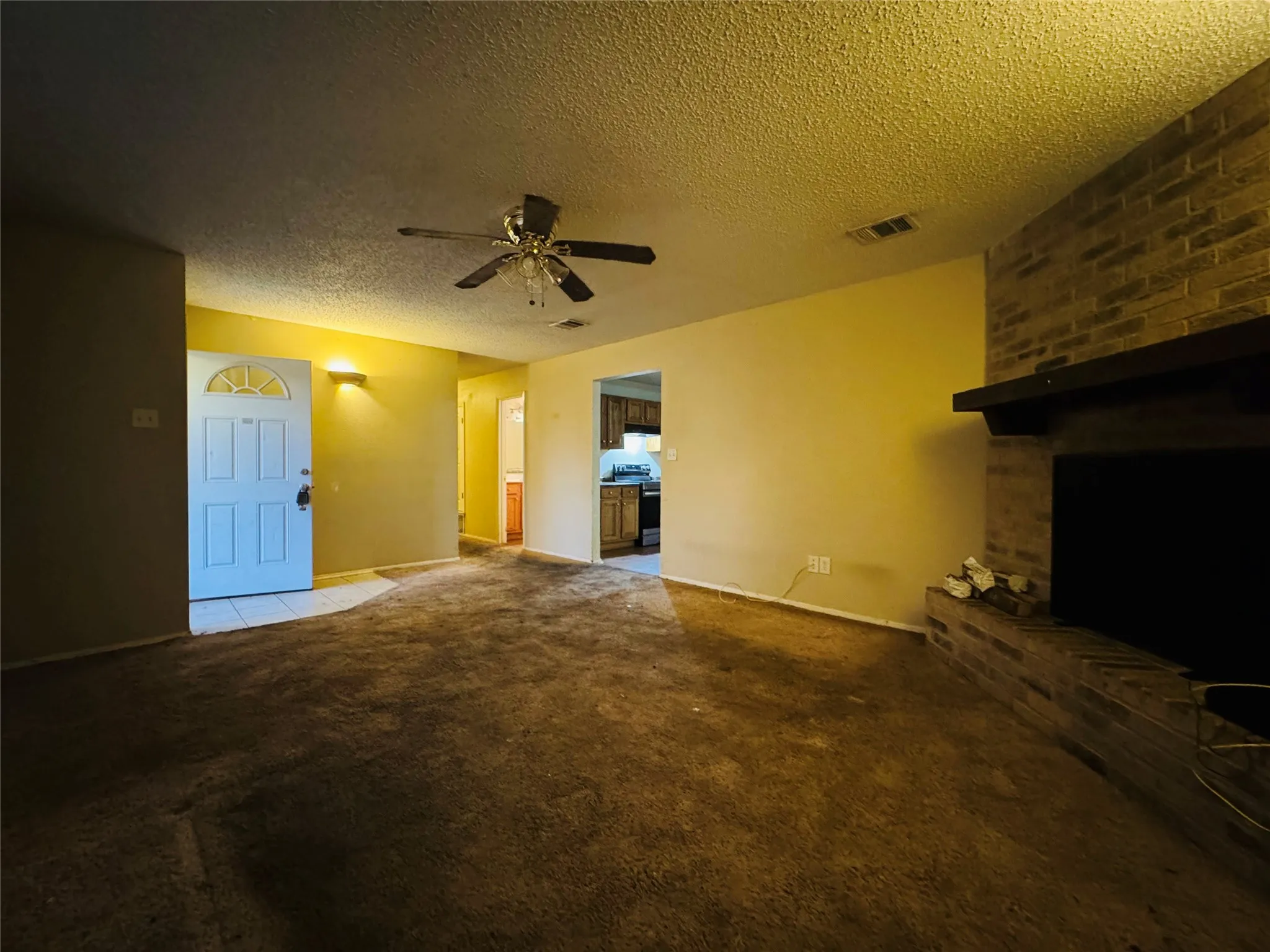 Brick fireplace with a dark wood mantle