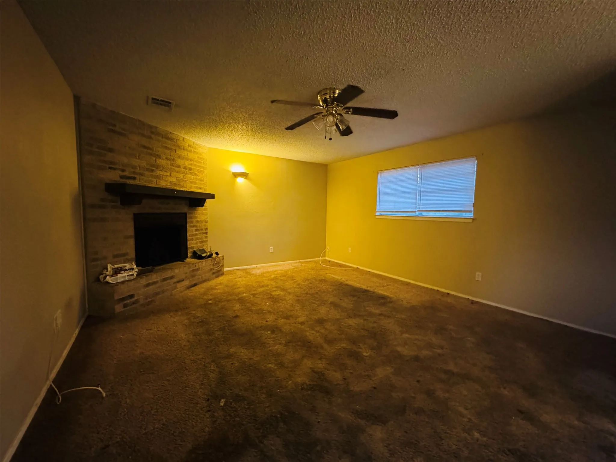 Brick-faced fireplace with a wood mantel