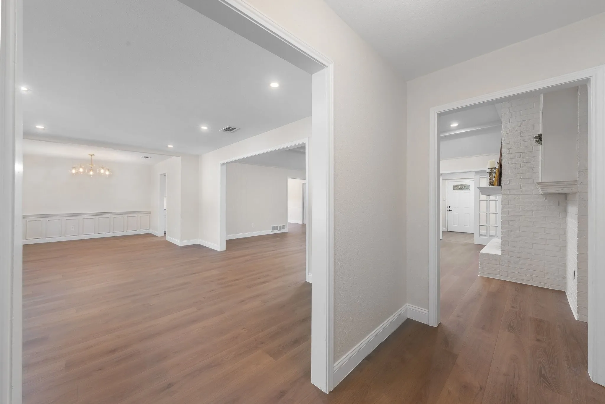 Warm new wood-finish flooring and recessed lighting throughout