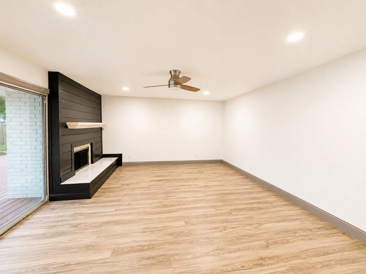 Wood-finish flooring, recessed lighting, and a ceiling fan