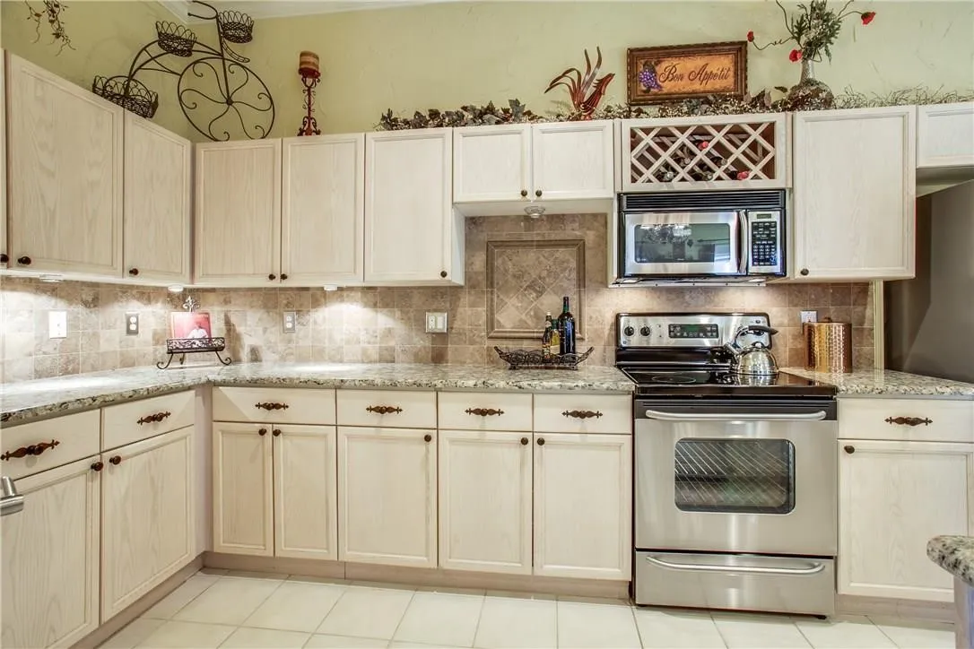 Light-finished cabinetry with decorative hardware