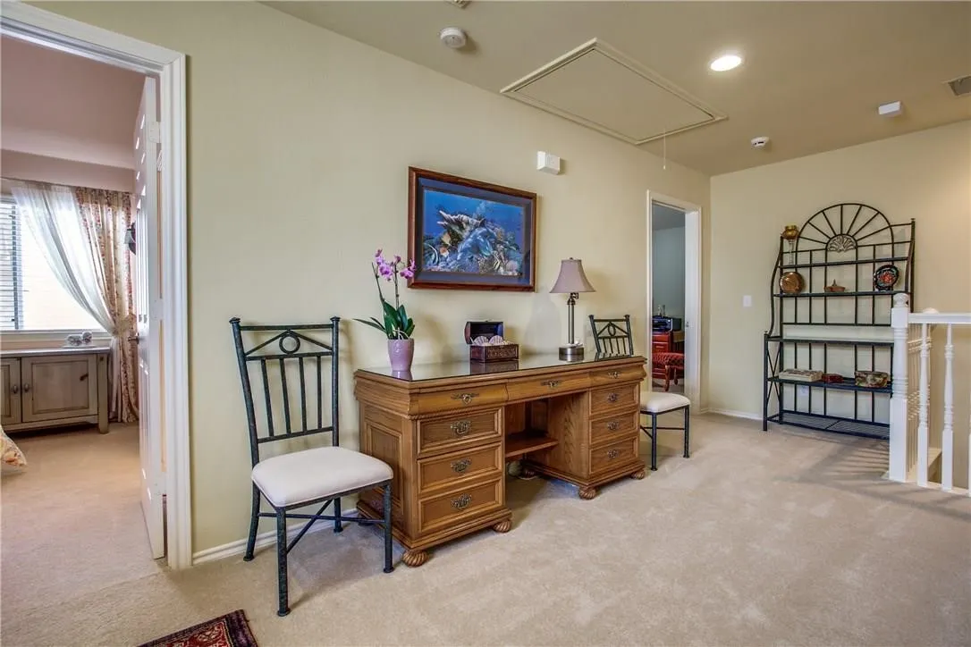 Carpeted floor, light-toned walls, overhead lighting, access panel, white railing