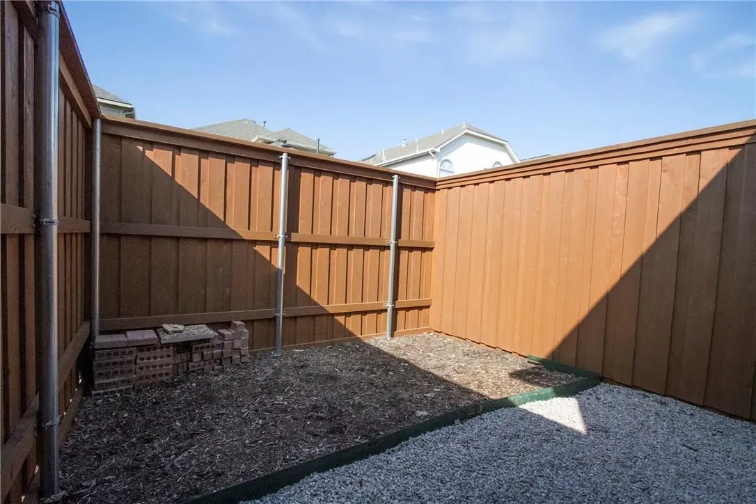 Private outdoor area featuring wood panel fencing