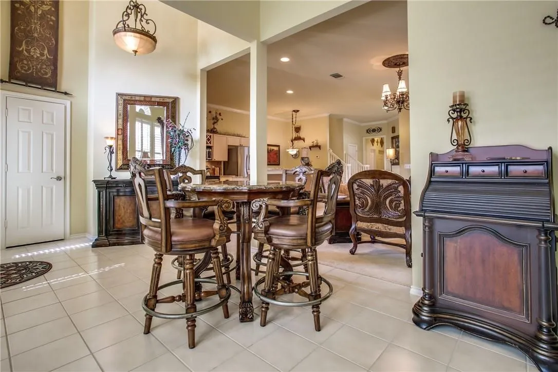 Tile flooring throughout with high ceilings and a decorative overhead light fixture
