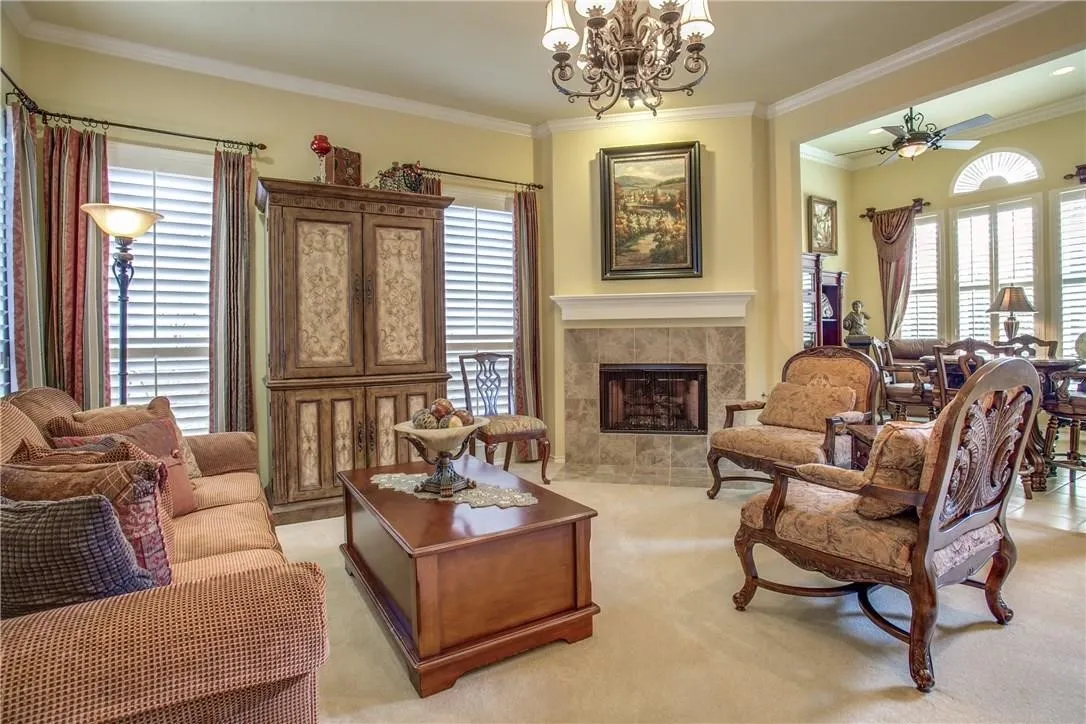 Carpeted living area with a built-in fireplace featuring a tile surround and mantel