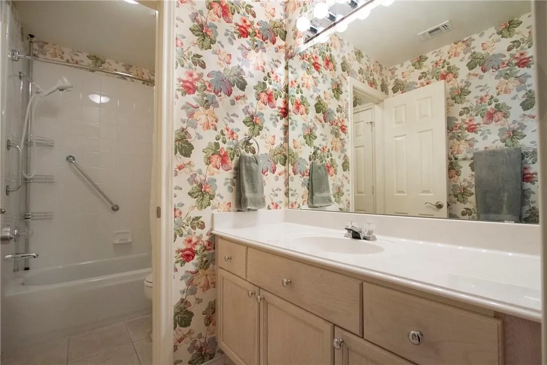 Single vanity with an integrated sink and light-toned cabinetry