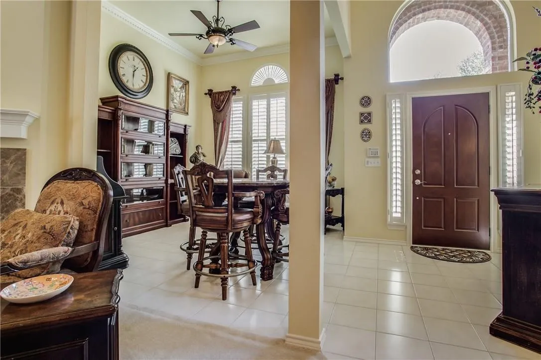 Arched entryway with a dark wood door, sidelight windows, and transom window