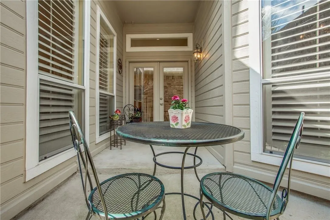 Private patio with concrete flooring, dual pane windows, and a double glass-panel door