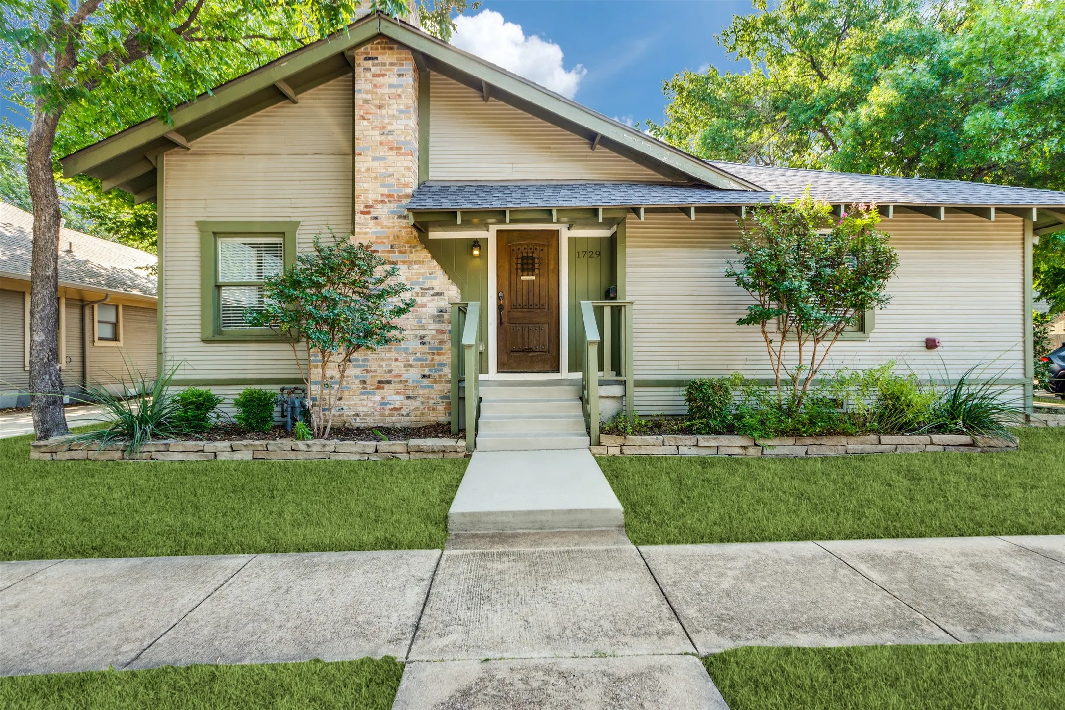 Traditional architecture with a gabled roof and brick chimney accent