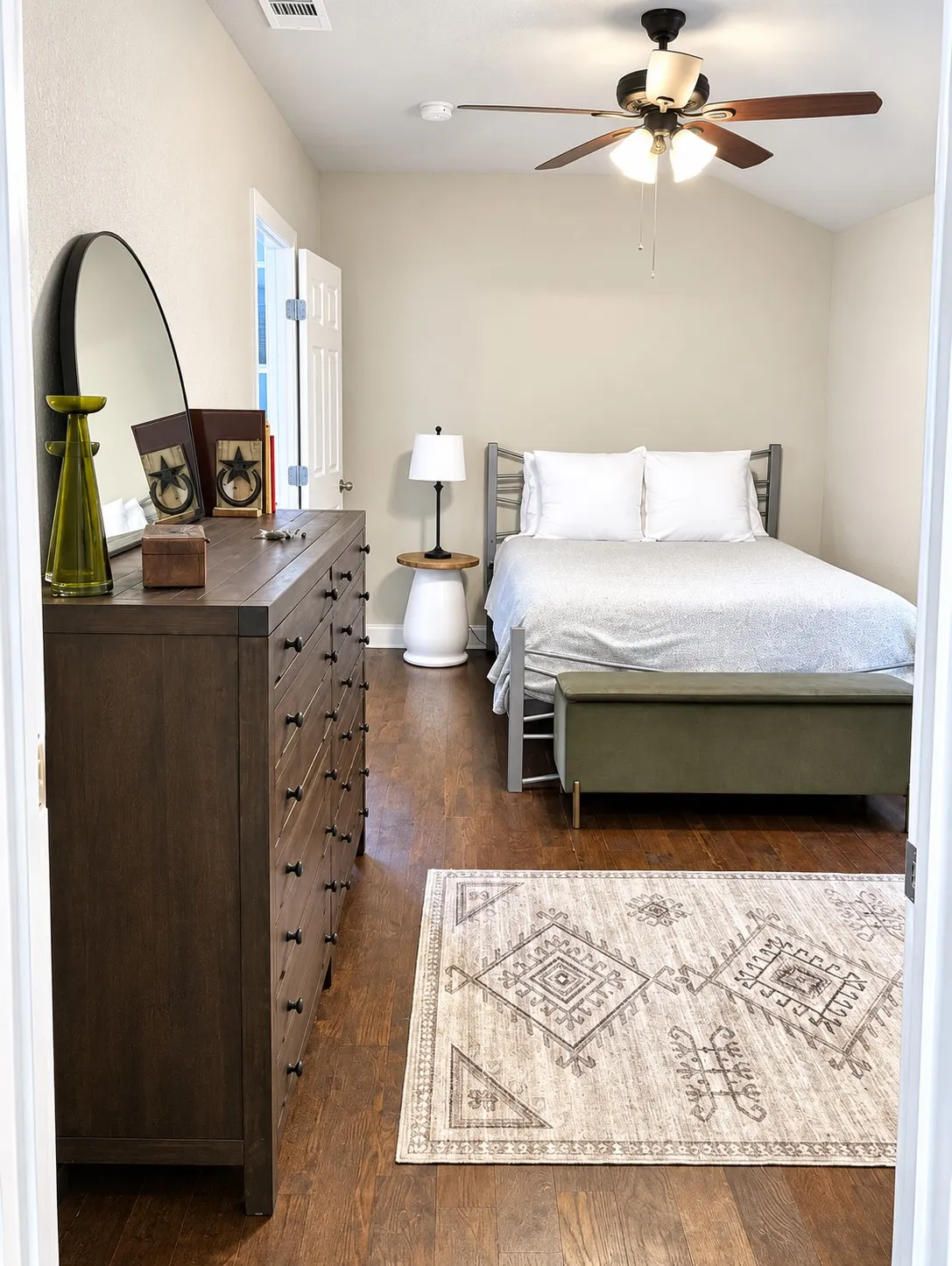 Wood-finish flooring throughout, featuring a vaulted ceiling with an attached ceiling fan