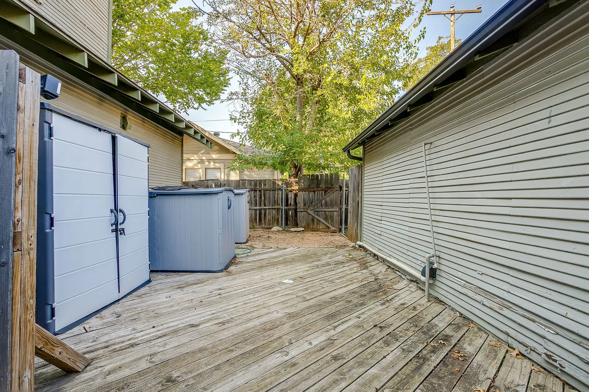 Spacious composite deck with wood-finish flooring, offering ample outdoor entertaining space