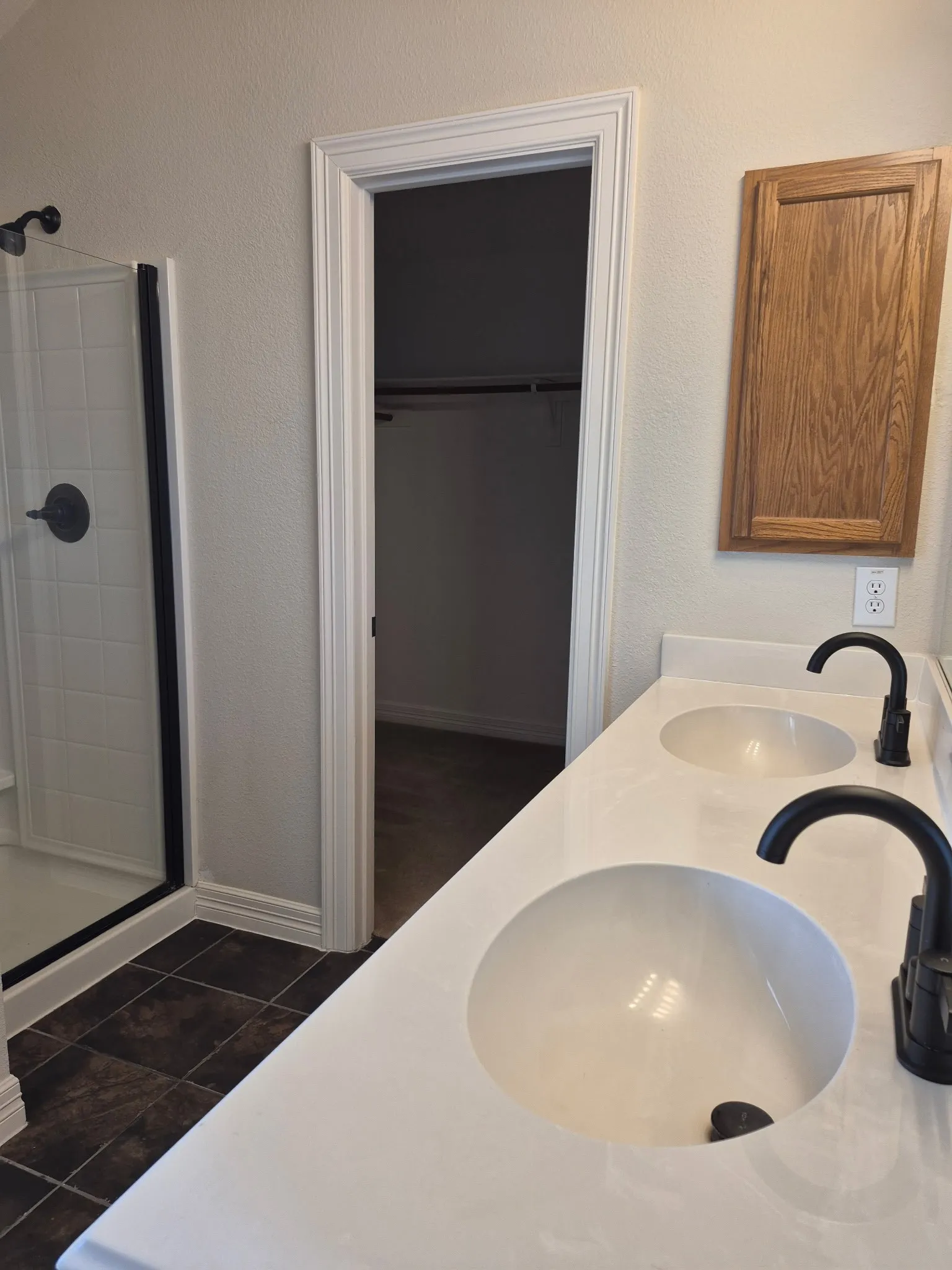 Dual vanity with integrated sinks, matte black faucets, and white countertop