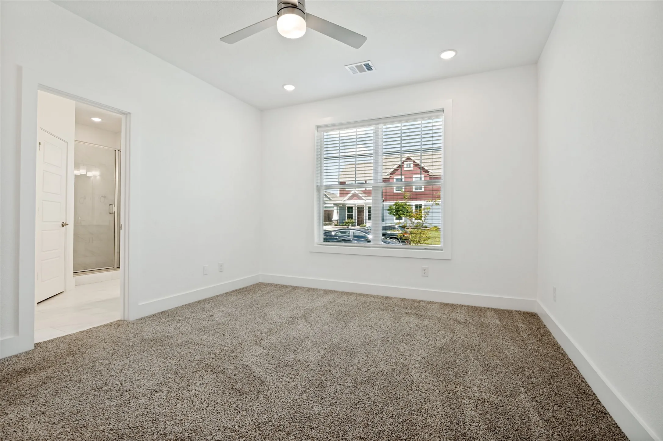 Recessed lighting, ceiling fan, white walls, carpeted flooring, and a window with blinds