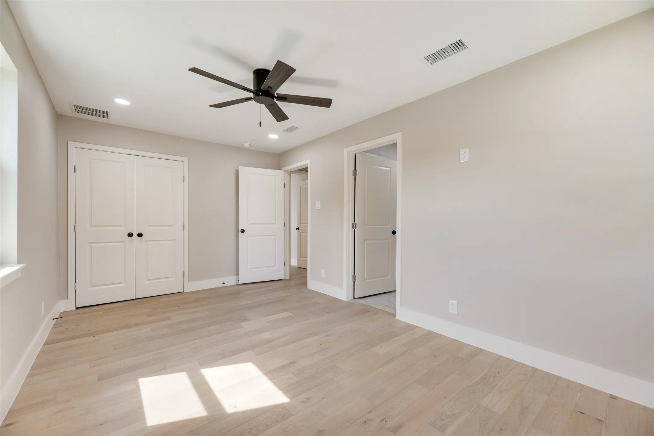 Master bedroom featuring recessed lighting, light wood-style flooring, ceiling fan, and a closet.