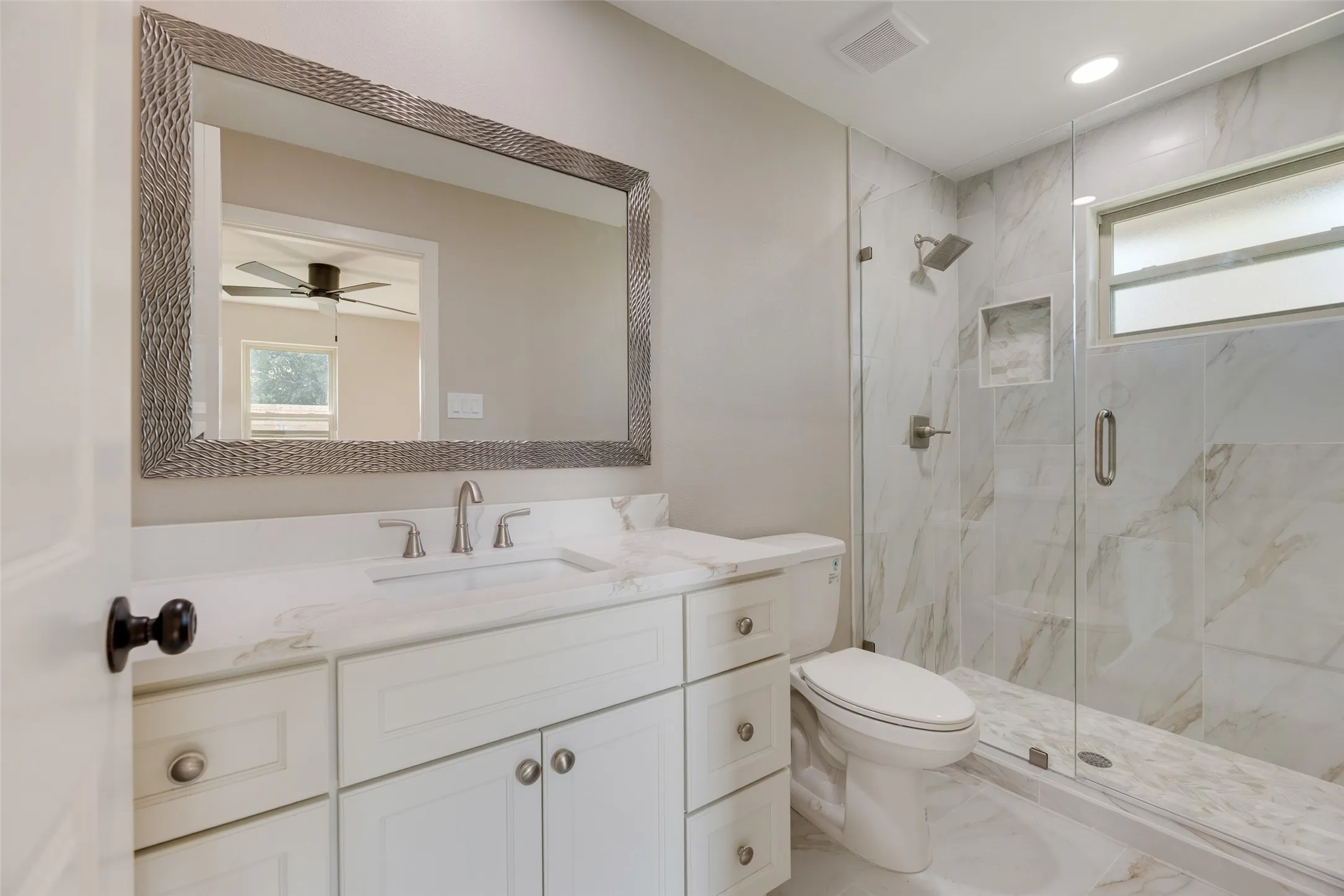  En suite Bath with plenty of natural light, quarts finished shower, vanity, and recessed lighting