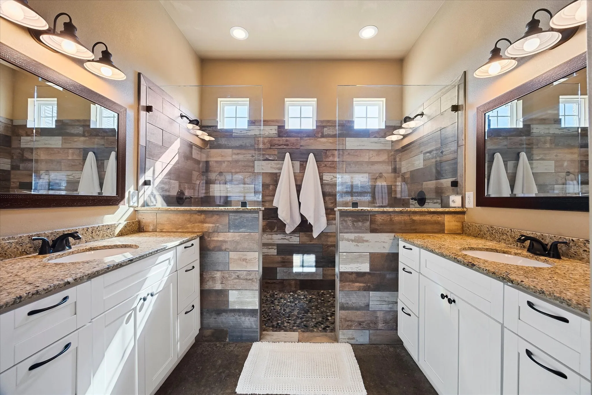 The primary bath offers separate vanities, oversized shower with dual heads and spacious walk-in closet with lots of built-ins.