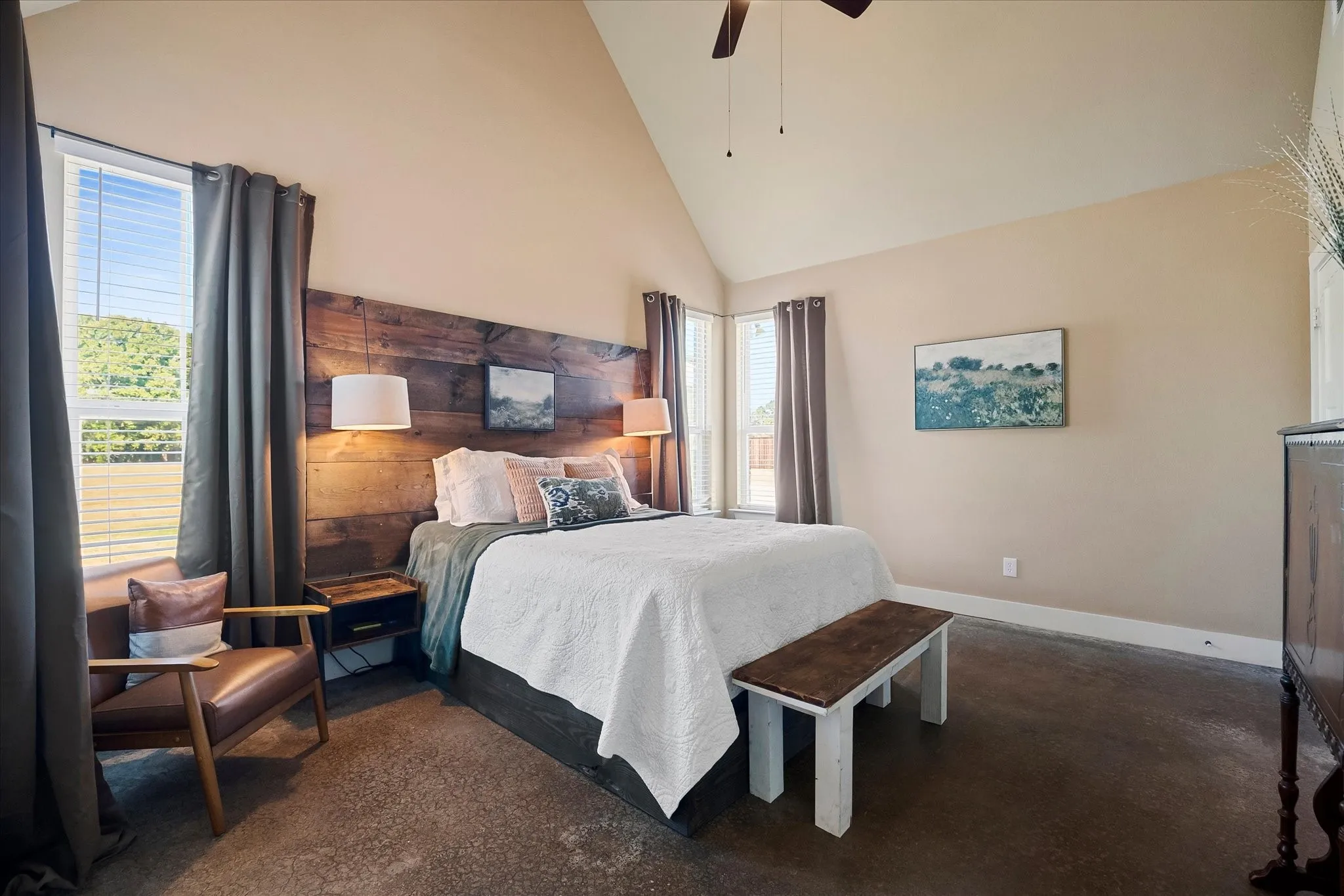 The secluded Primary Retreat features a soaring ceiling. The custom headboard can stay or be removed.