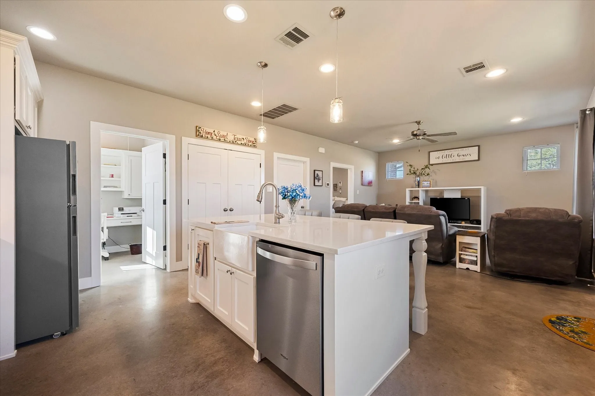 The large kitchen island has a farm sink, breakfast bar seating and storage on both sides.