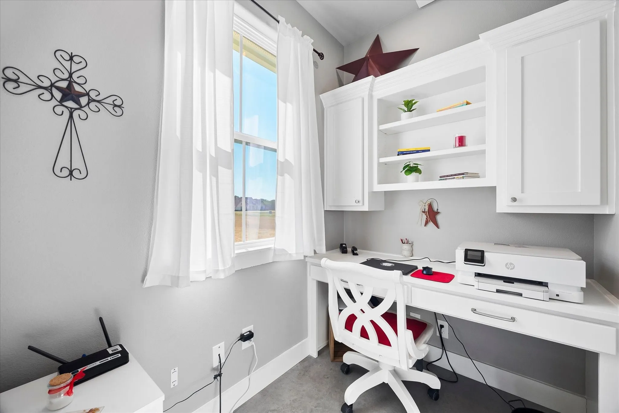 The cozy office is super functional with its built-in desk and storage.