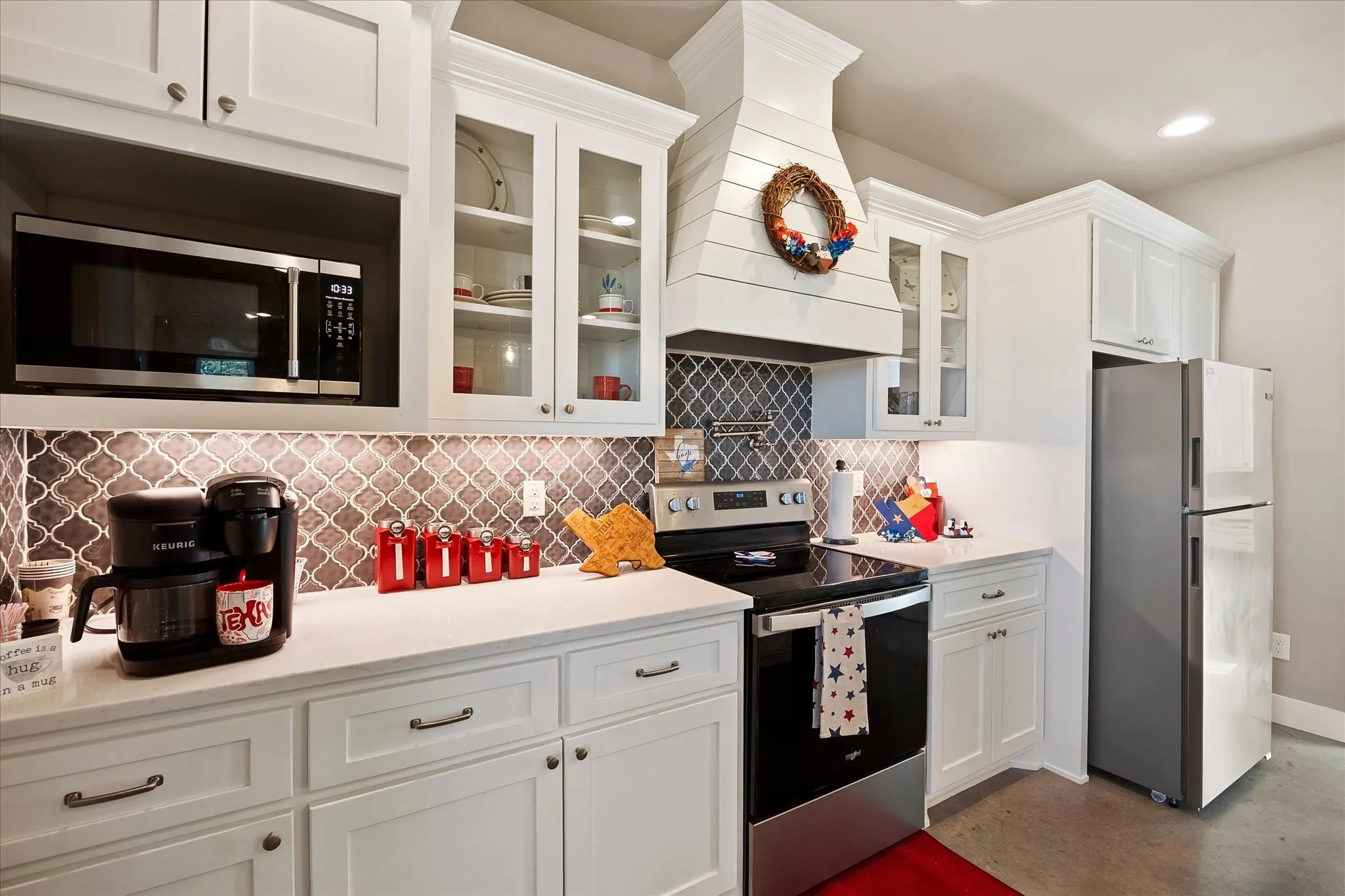 The kitchen has quartz counter tops and a gorgeous backsplash.