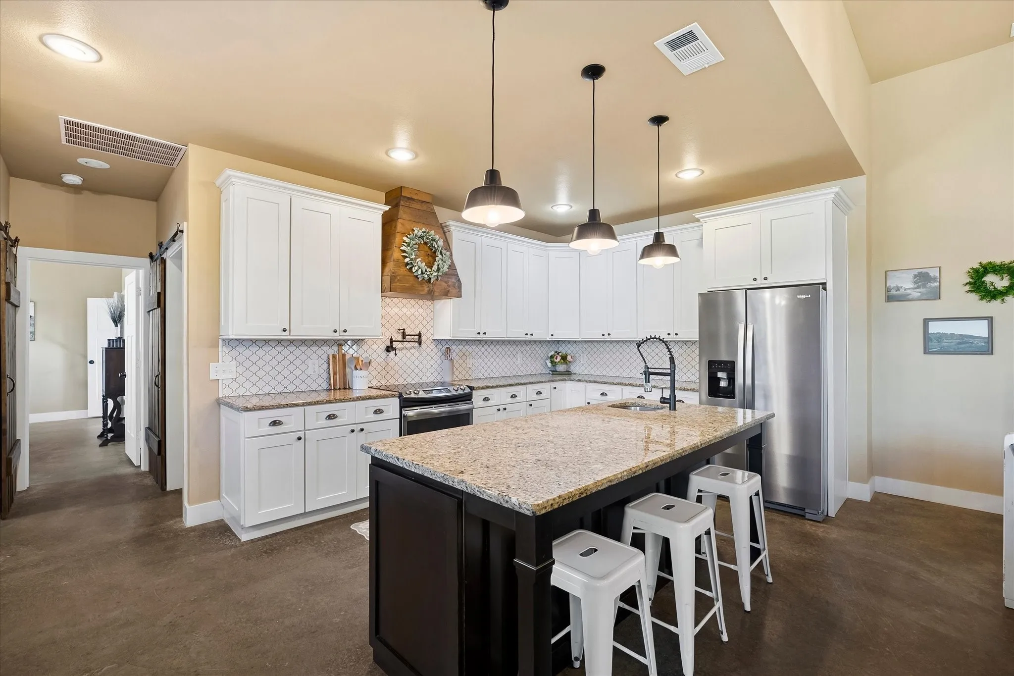 Whip up culinary delights in the well-equipped kitchen that offers an abundance of cabinetry and granite-topped workspace.