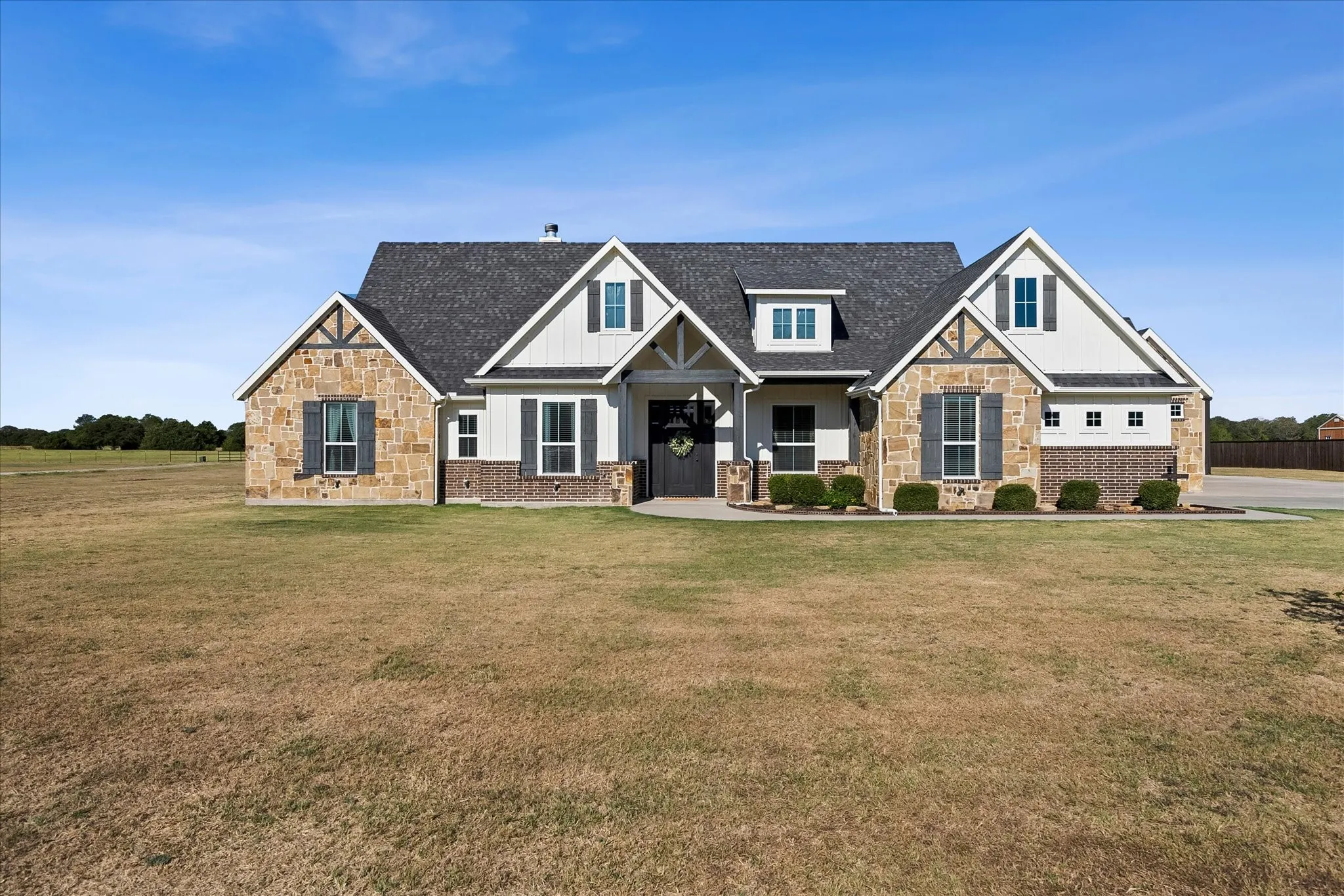 This gorgeous custom home blends charming Craftsman style with modern Farmhouse elements.