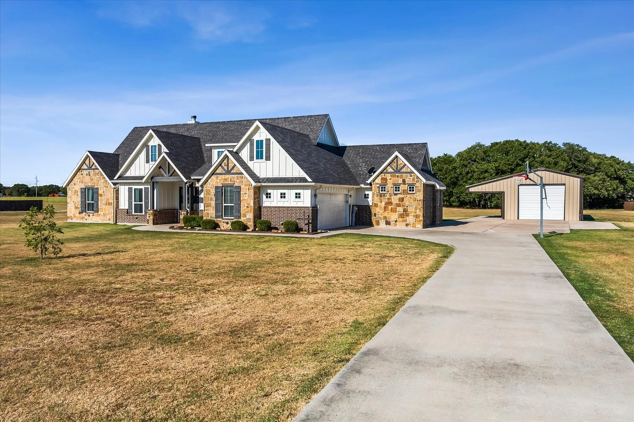 There's an abundance of protected and open parking between the oversized garage, workshop with RV/boat overhang and expanded driveway.