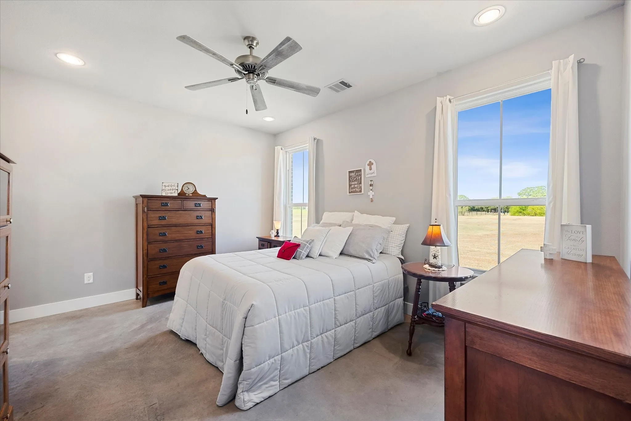 The spacious bedroom has a ceiling fan and huge walk-in closet.