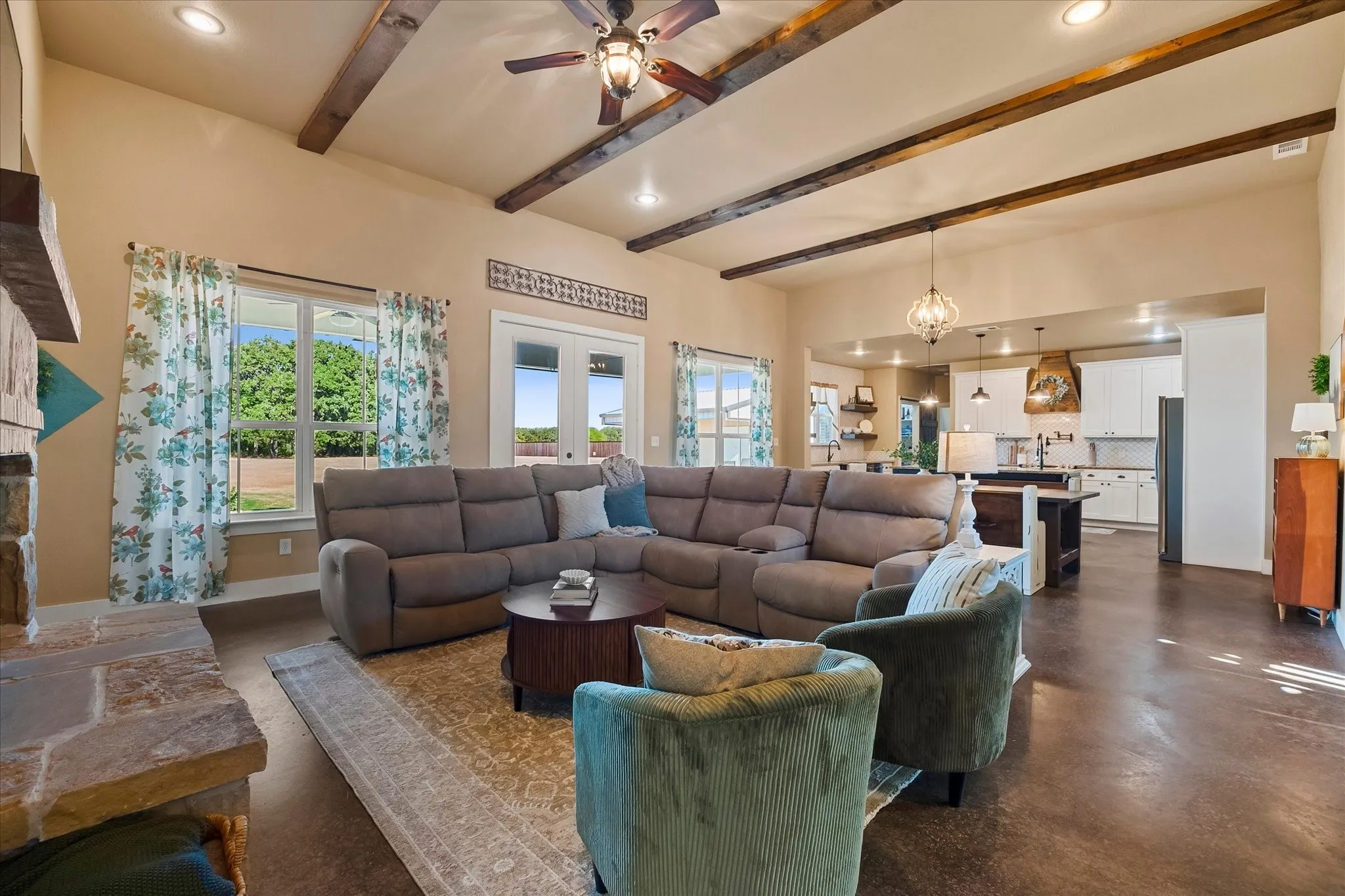 Richly stained beams add rustic charm to the high ceilings of the living and dining areas.