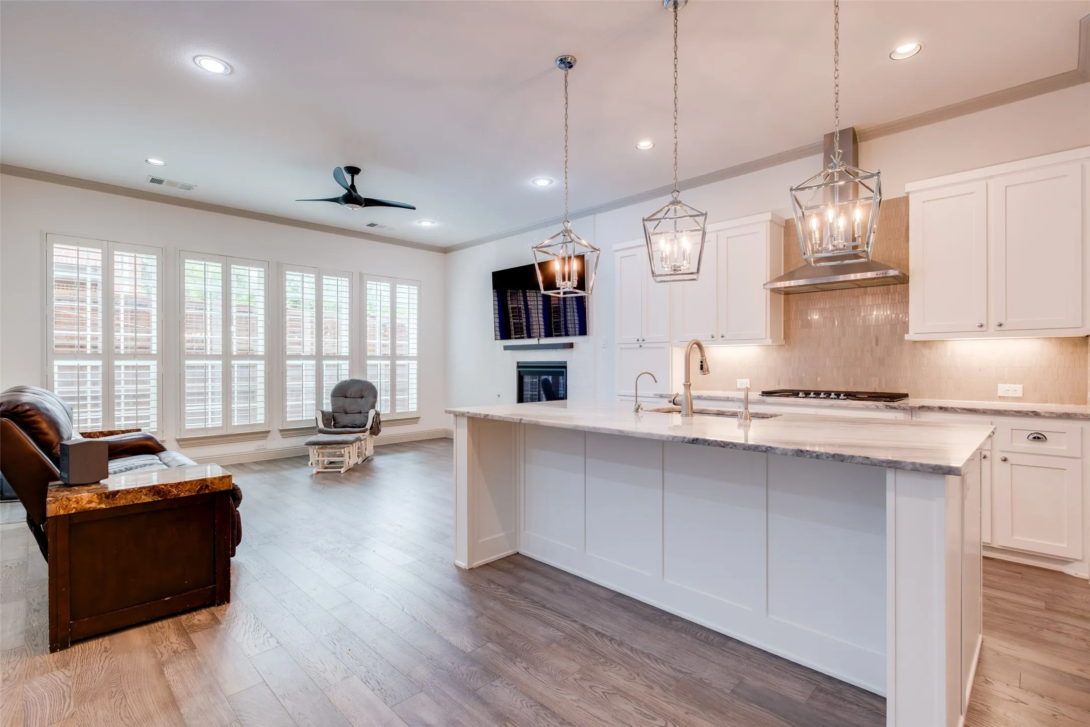Open concept kitchen and family room with large wall of windows.