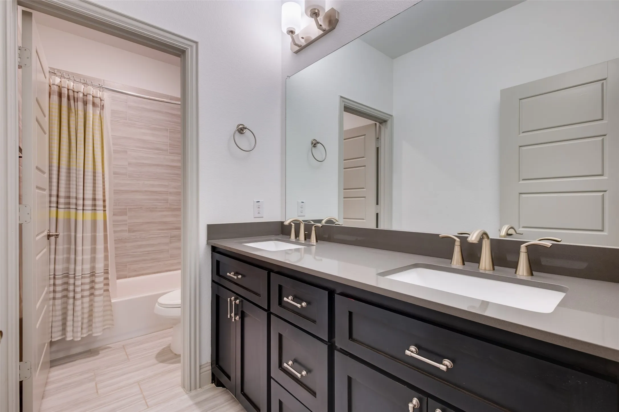 Large secondary bathroom with dual sinks and lots of storage