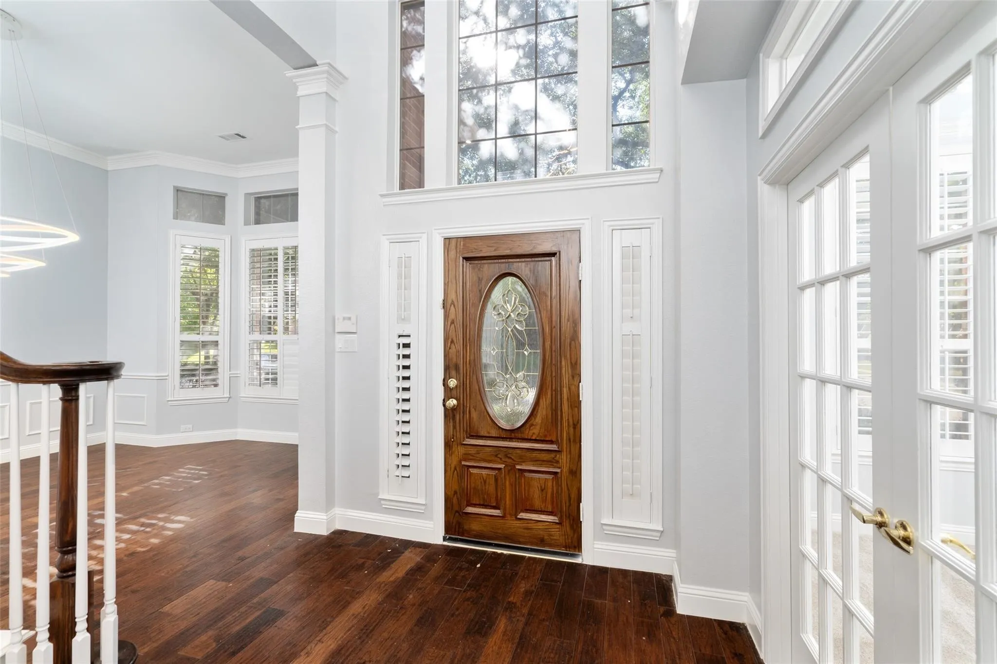 Grand entry with a rich wood-finish door featuring leaded glass
