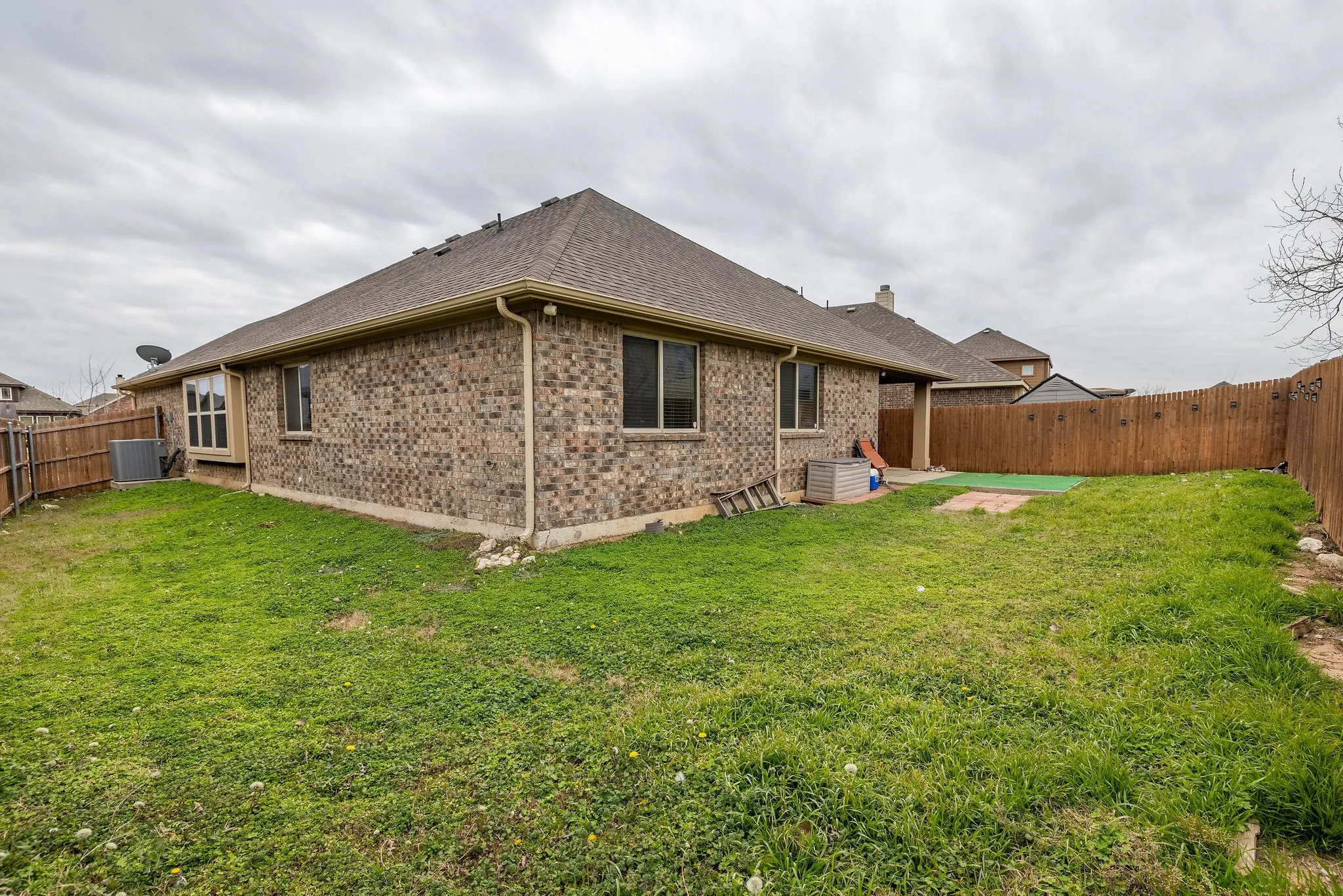 Rear view of house featuring patio area, and lawn
