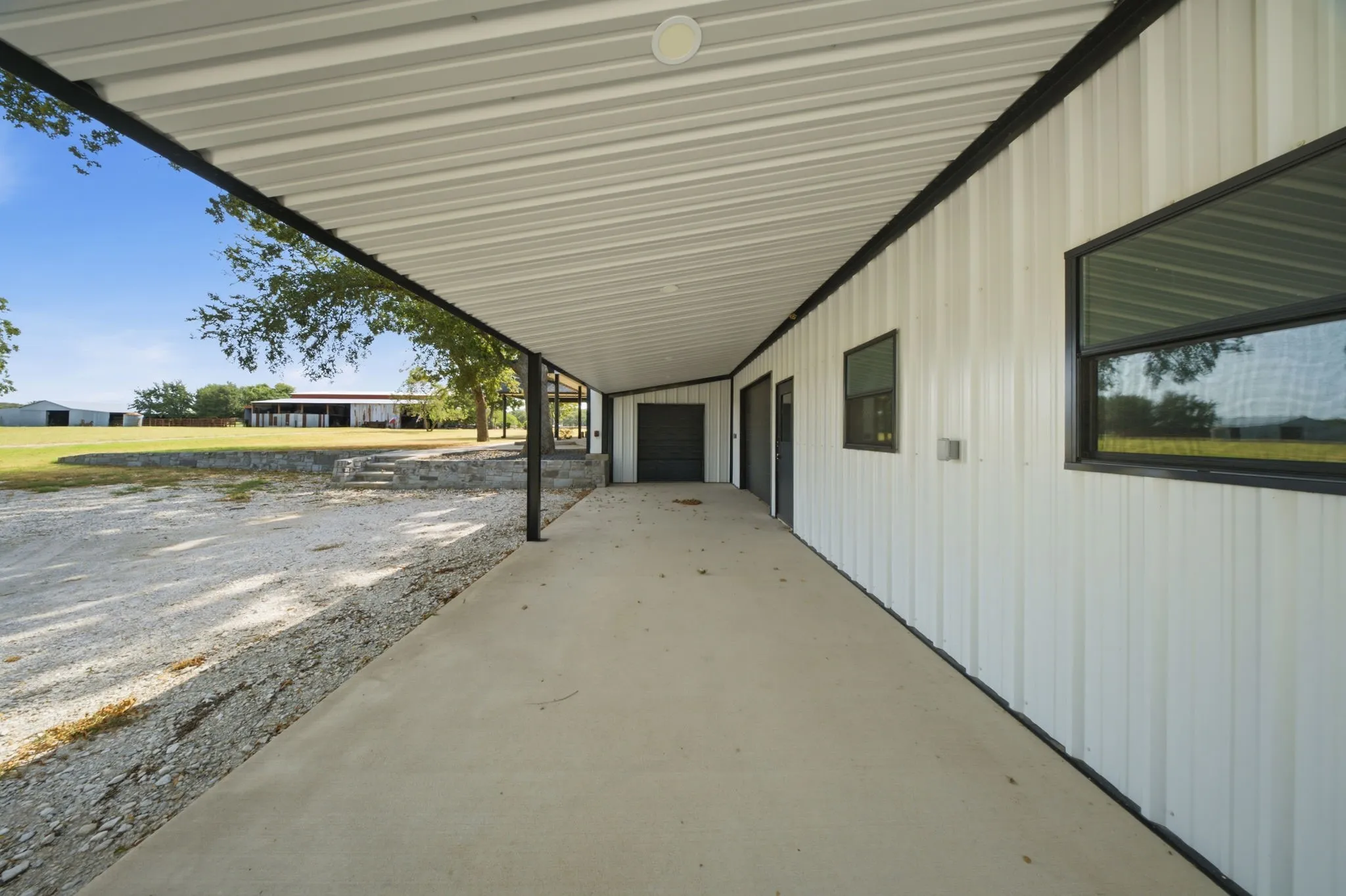 Large covered carport / Patio / Parking with an attached 3 Car OVERSIZED Garage with a loft for storage.