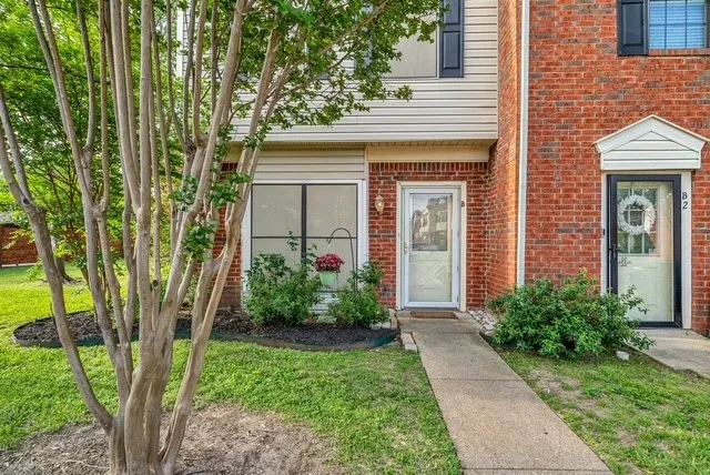 Brick and siding exterior with mature landscaping