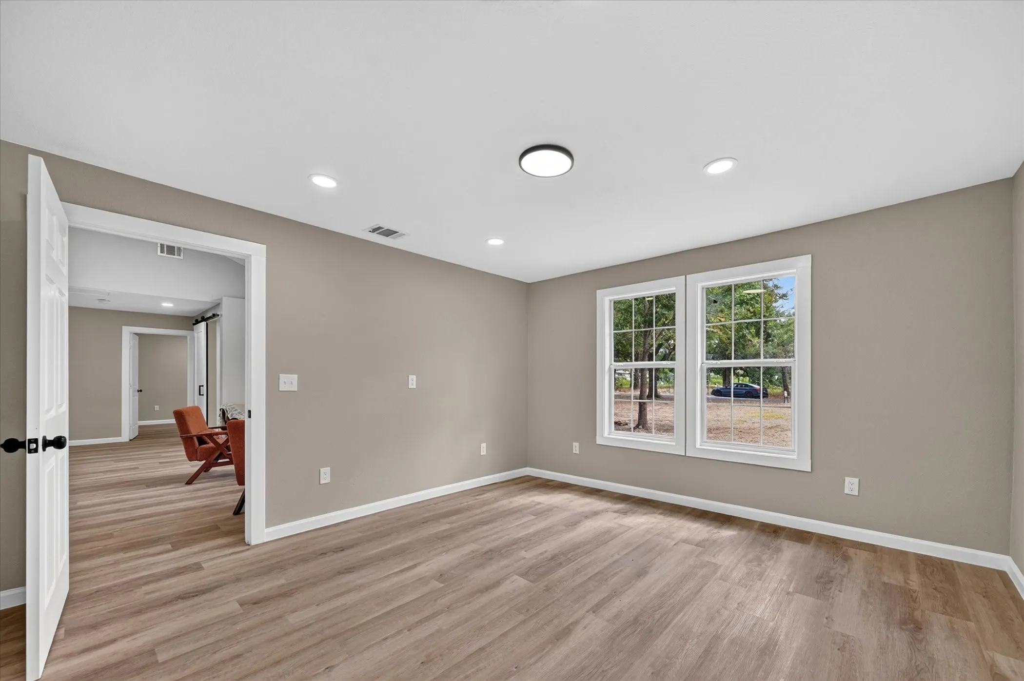 Wood-finish flooring throughout, recessed lighting, double-pane windows, and a flush mount ceiling light