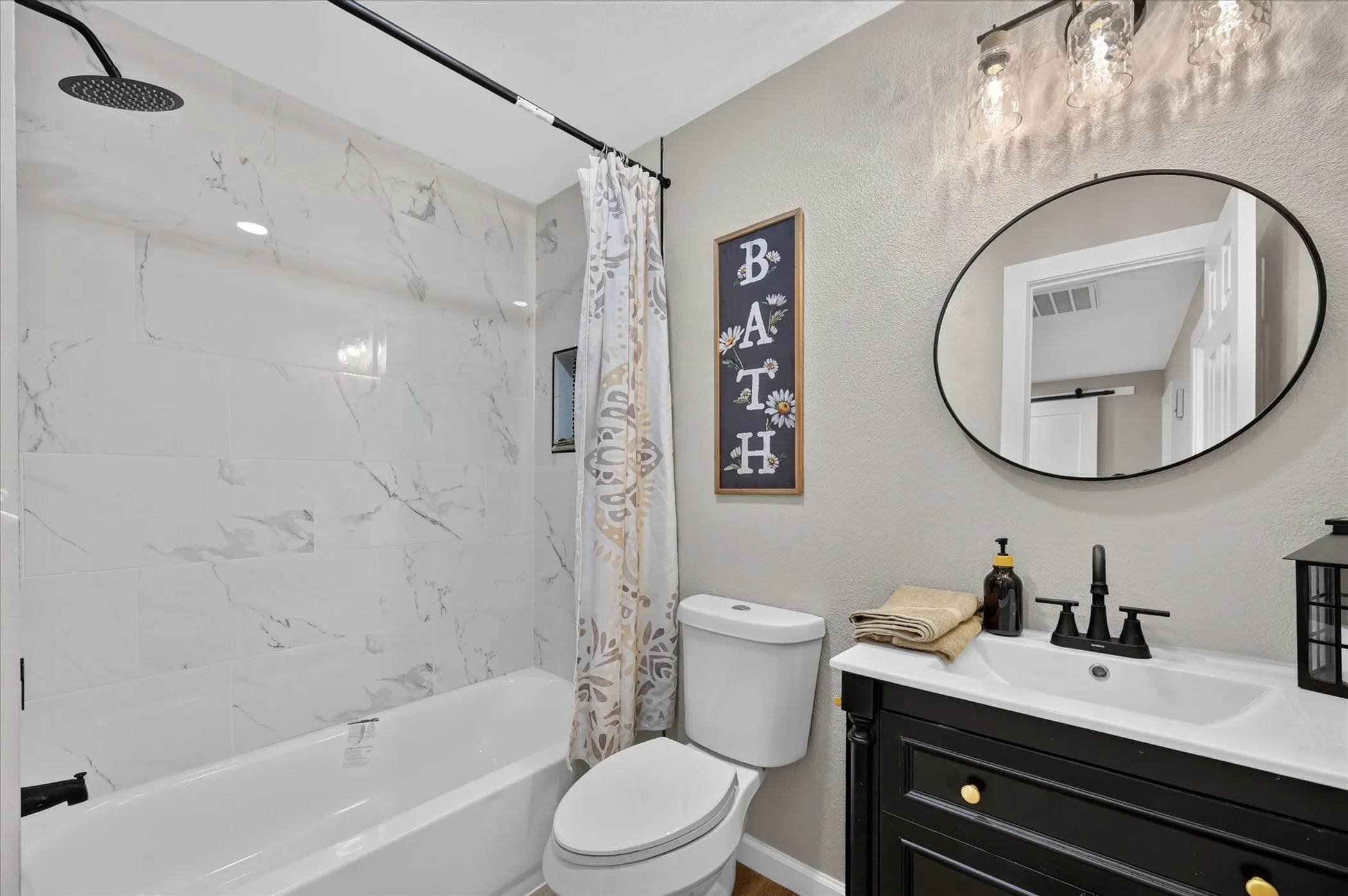 Bathroom #1 Tub/shower combination featuring large format tile surround and rain shower head