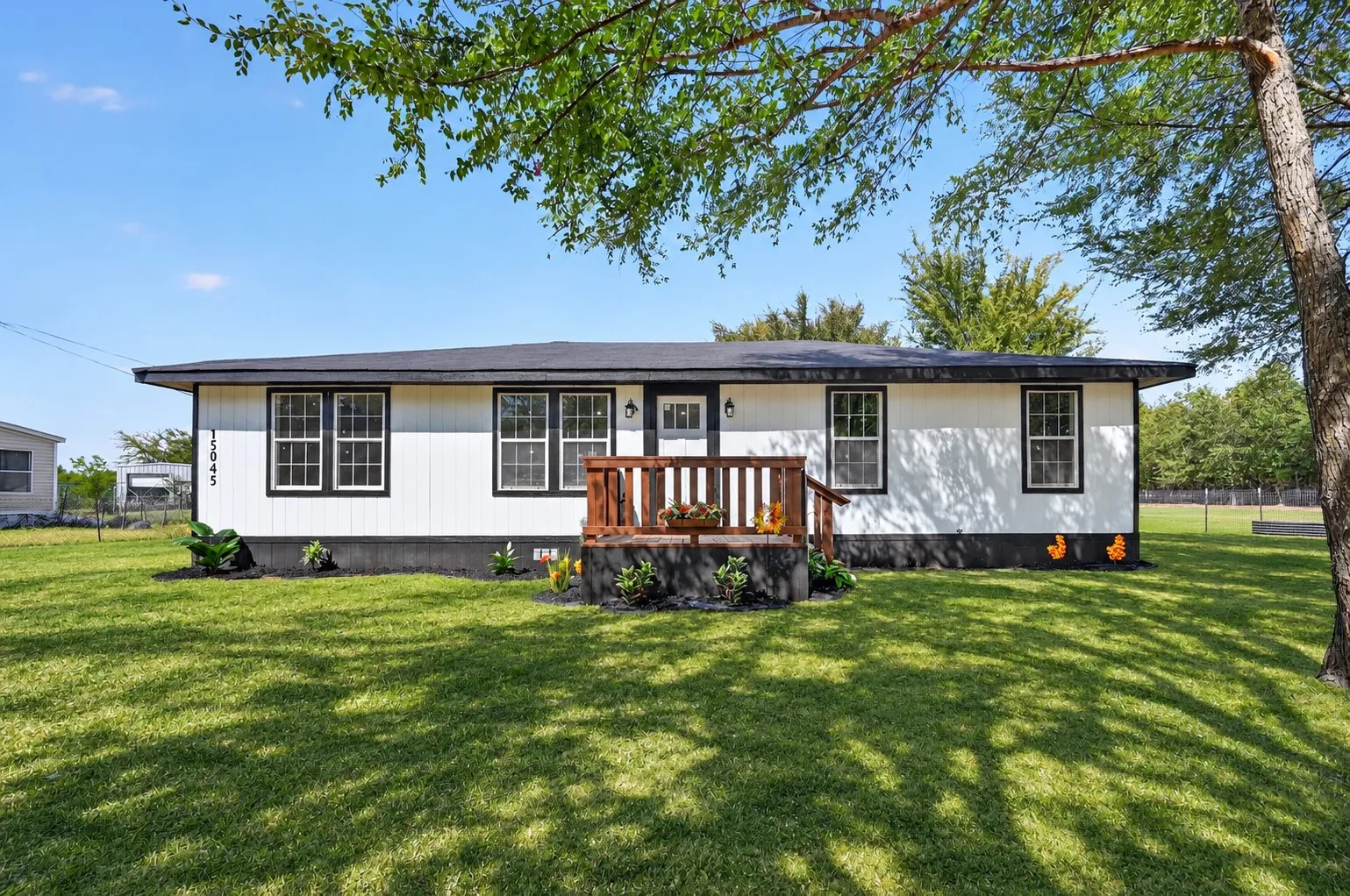 Grass is AI.. Crisp white exterior with contrasting black trim