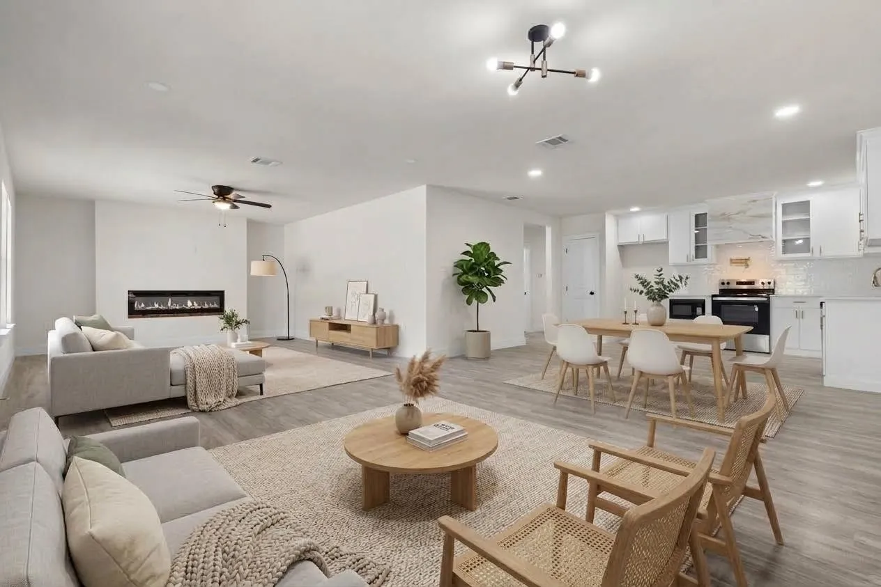 Open-concept living space featuring wood-finish flooring, recessed lighting, and a modern linear fireplace