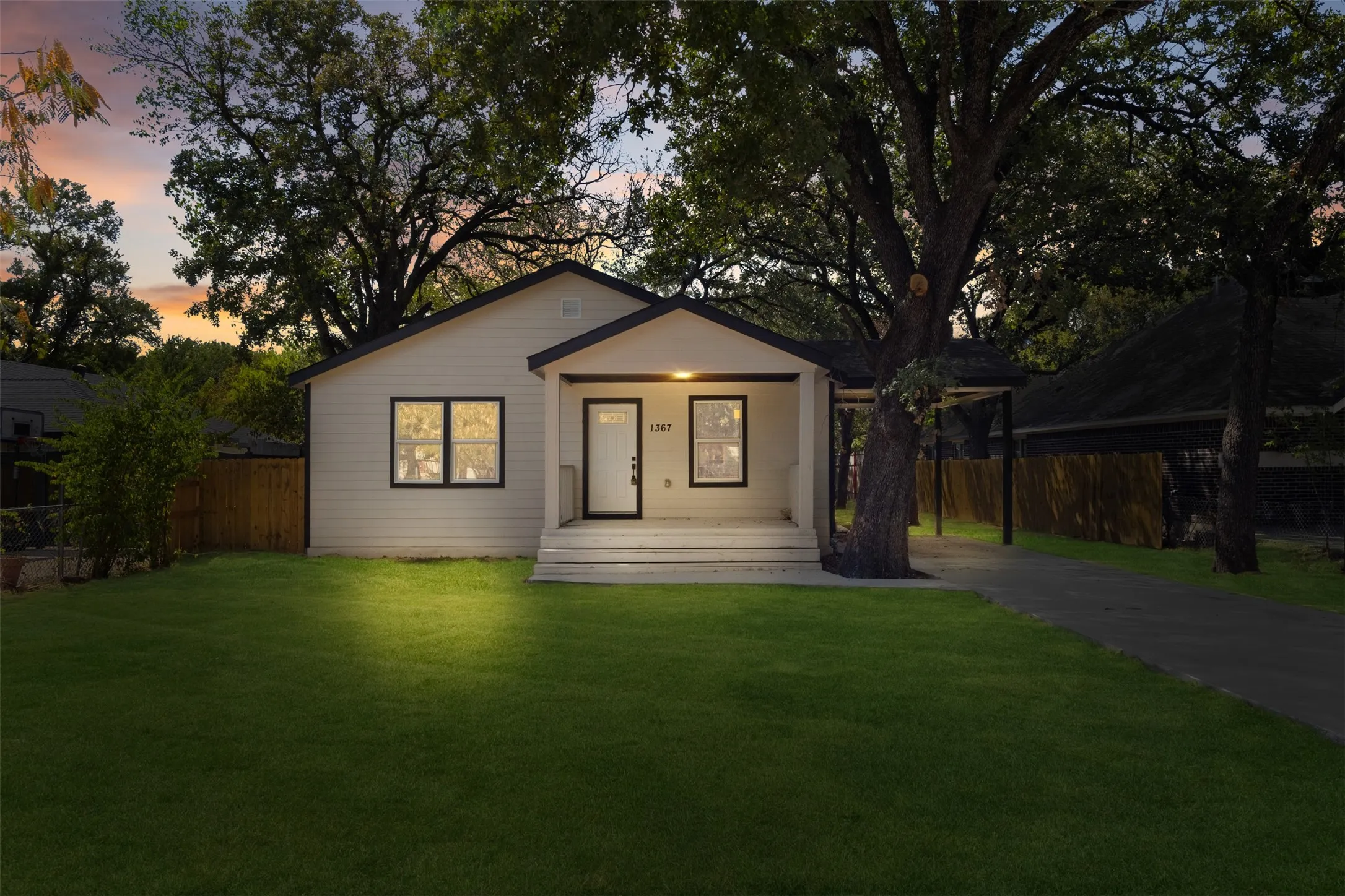 White siding exterior with a dark-trimmed front door and windows