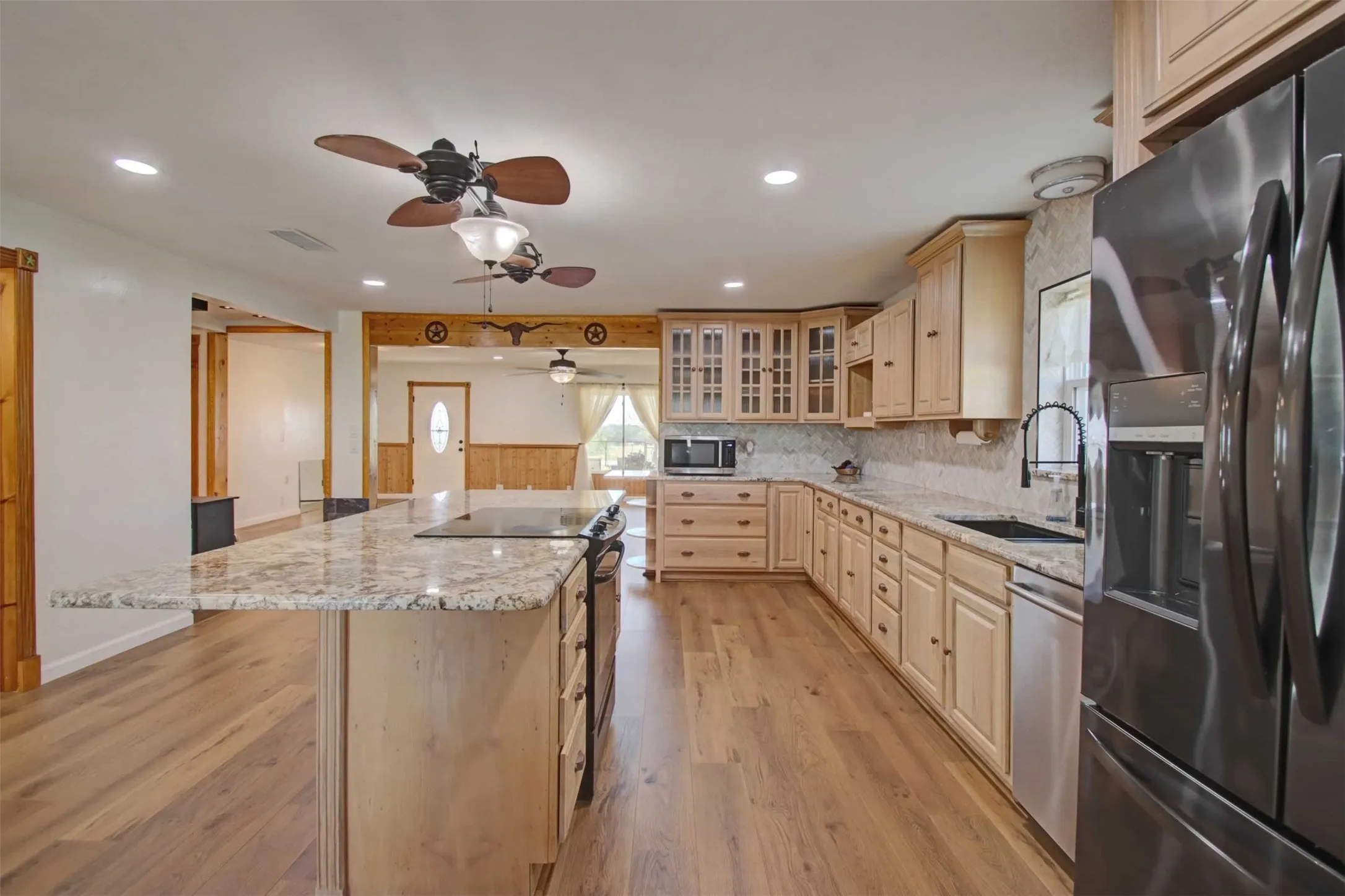 You could easily seat six people at this island for a casual breakfast or lunch.   There is an abundance of over and under cabinets and counter space.