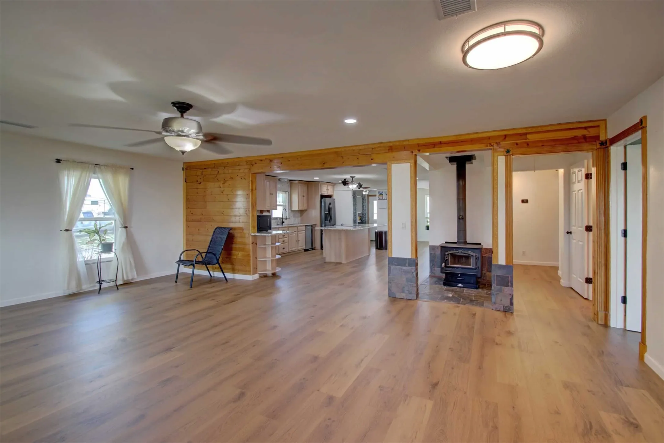 As you enter there are several things that catch your eye. The open floor plan reveals the huge kitchen island that can seat at least 6 people for those informal meals with your family or guests.  The free standing wood burning fireplace is centrally located and heats most of the home on our cold winter nights. Don't overlook the freshly painted walls and newly installed floors.