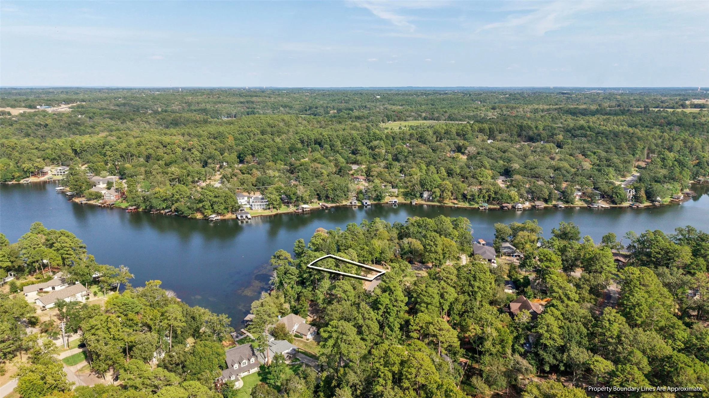 Waterfront property with mature trees and a defined lot boundary
