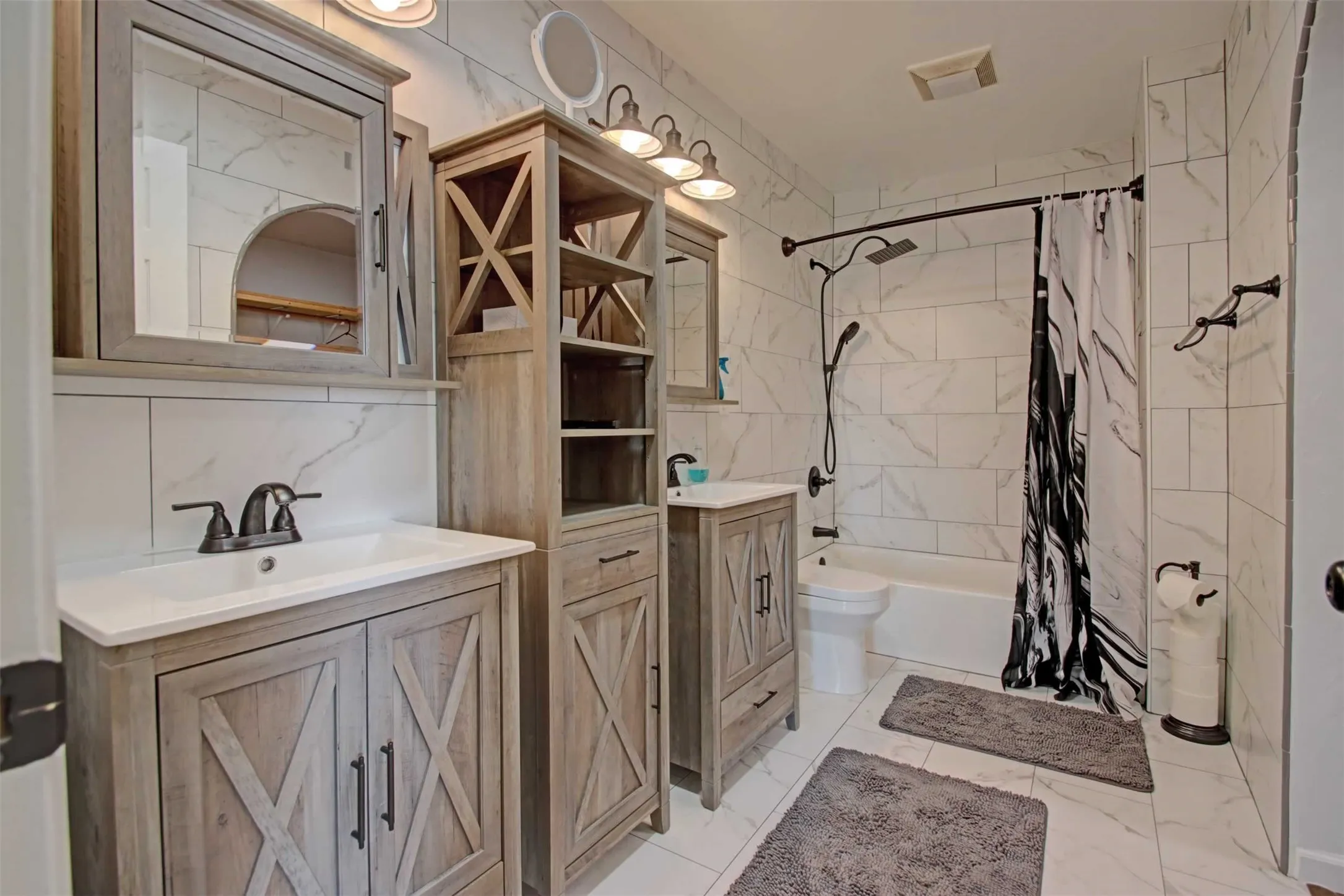 Recently remodeled primary bath has double sinks and mirrors with lots of storage. There's also an attached large walk in closet.