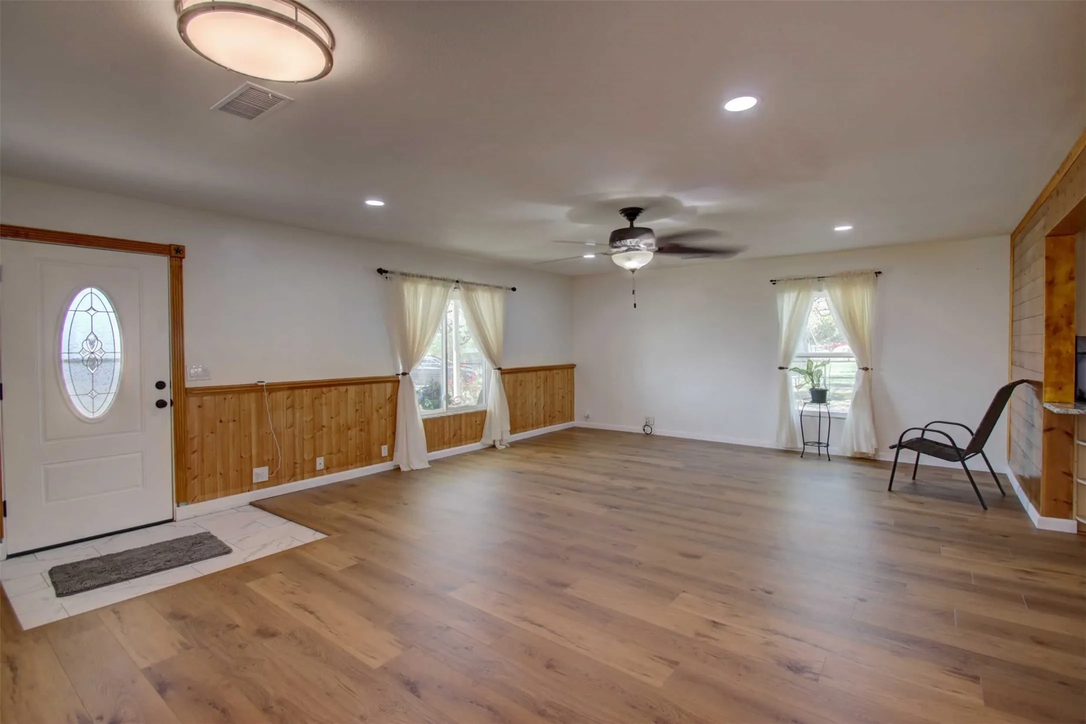 Another look at the large living room. Notice the beautiful fan and great overhead lighting.
