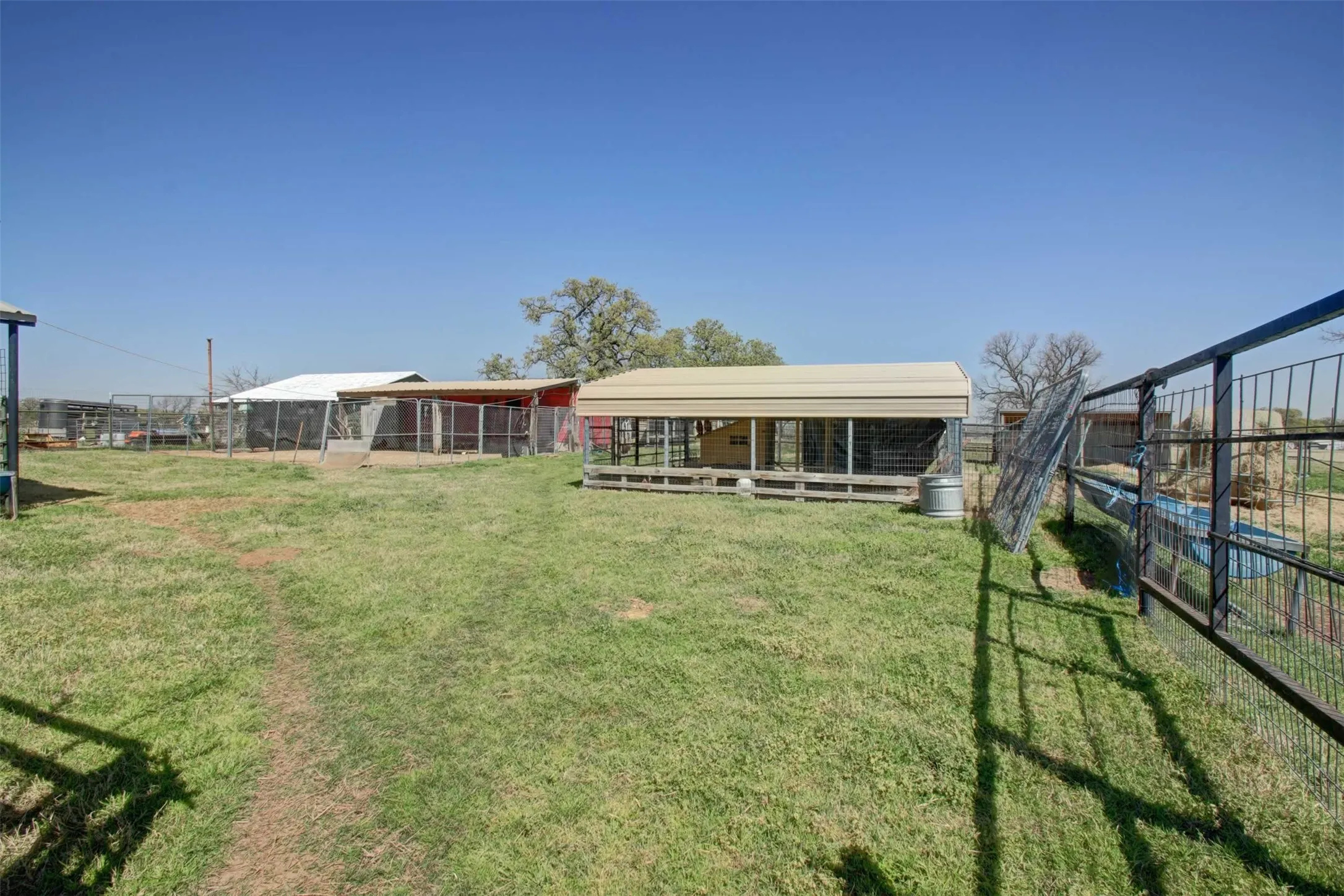 2 separate chicken coops. Even the coops have metal roofs