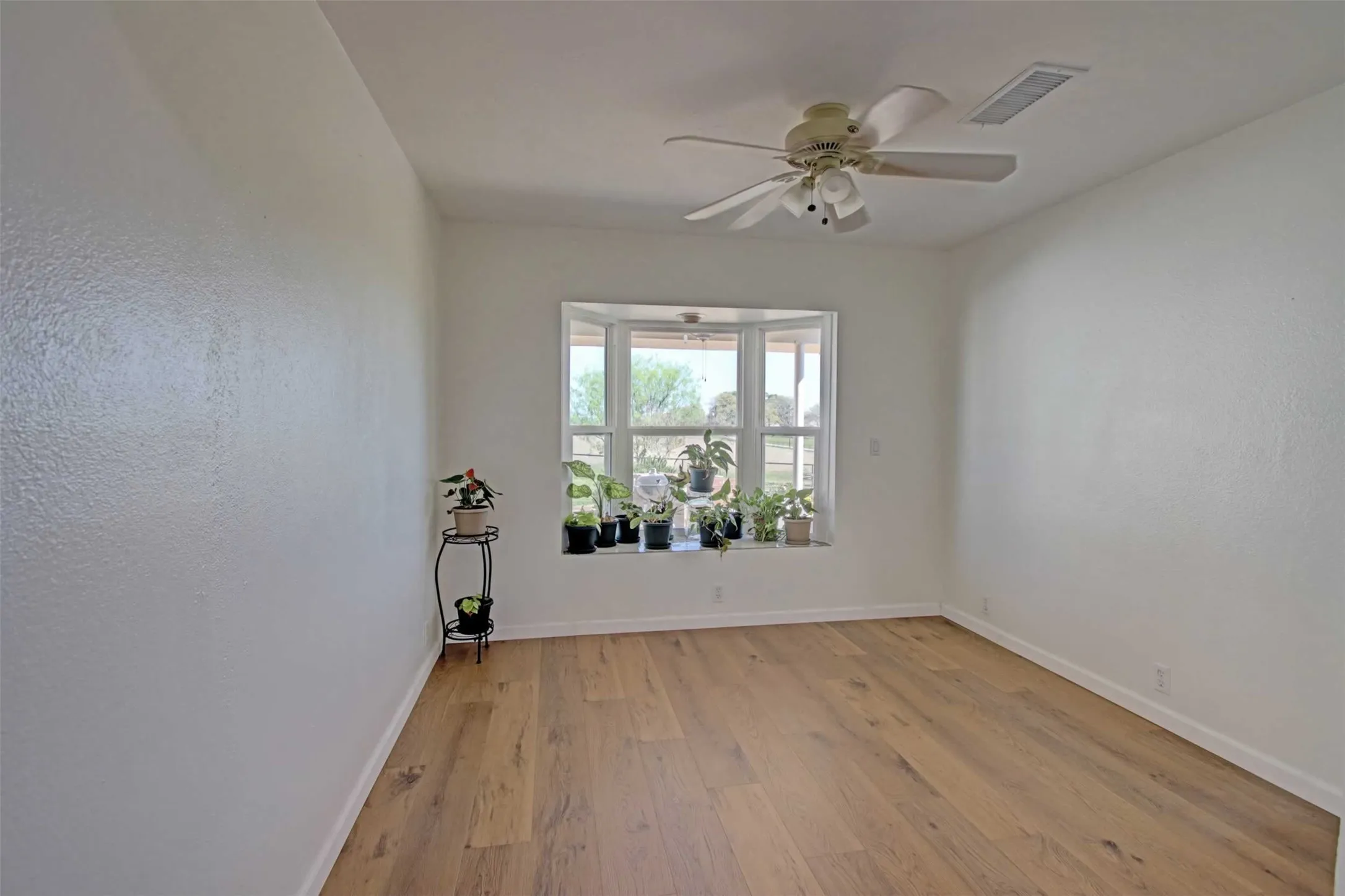 The formal dining room has a bay window that looks out to the covered patio and the hay fields beyond. There's also a comfortable bay window for displaying your favorite flora or decorative keepsakes.